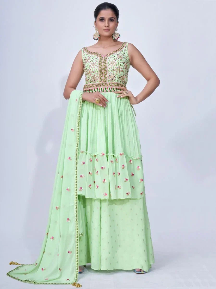 Woman wearing a mint green embroidered lehenga choli with dupatta, Indian ethnic outfit