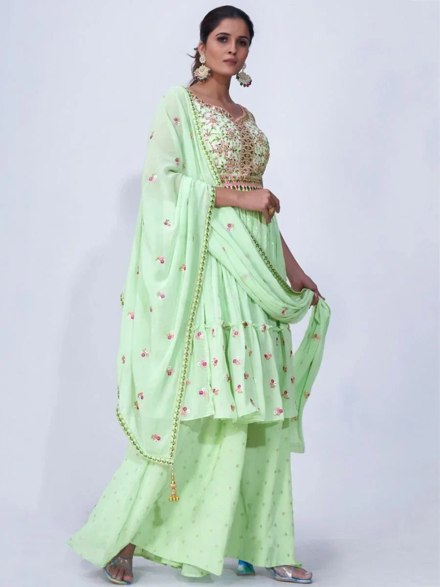 Woman wearing light green embroidered ethnic suit with sharara pants and dupatta