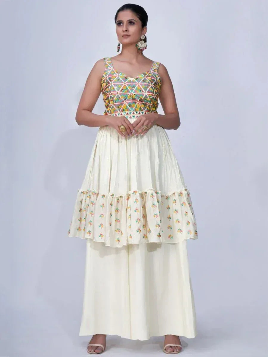 Woman wearing cream ethnic gown with multicolor embroidered bodice and floral detailing