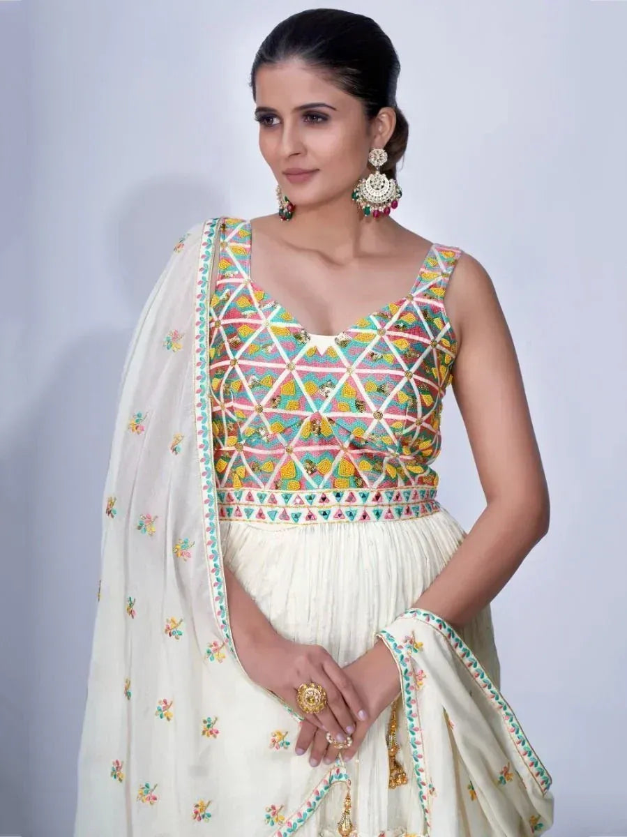 Woman in cream embroidered lehenga choli with colorful geometric blouse and matching dupatta