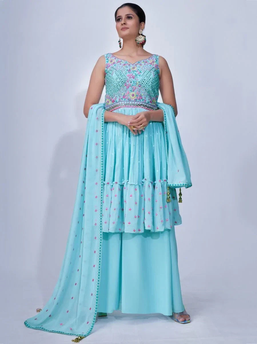 Woman in light blue embroidered ethnic gown with dupatta and floral patterns