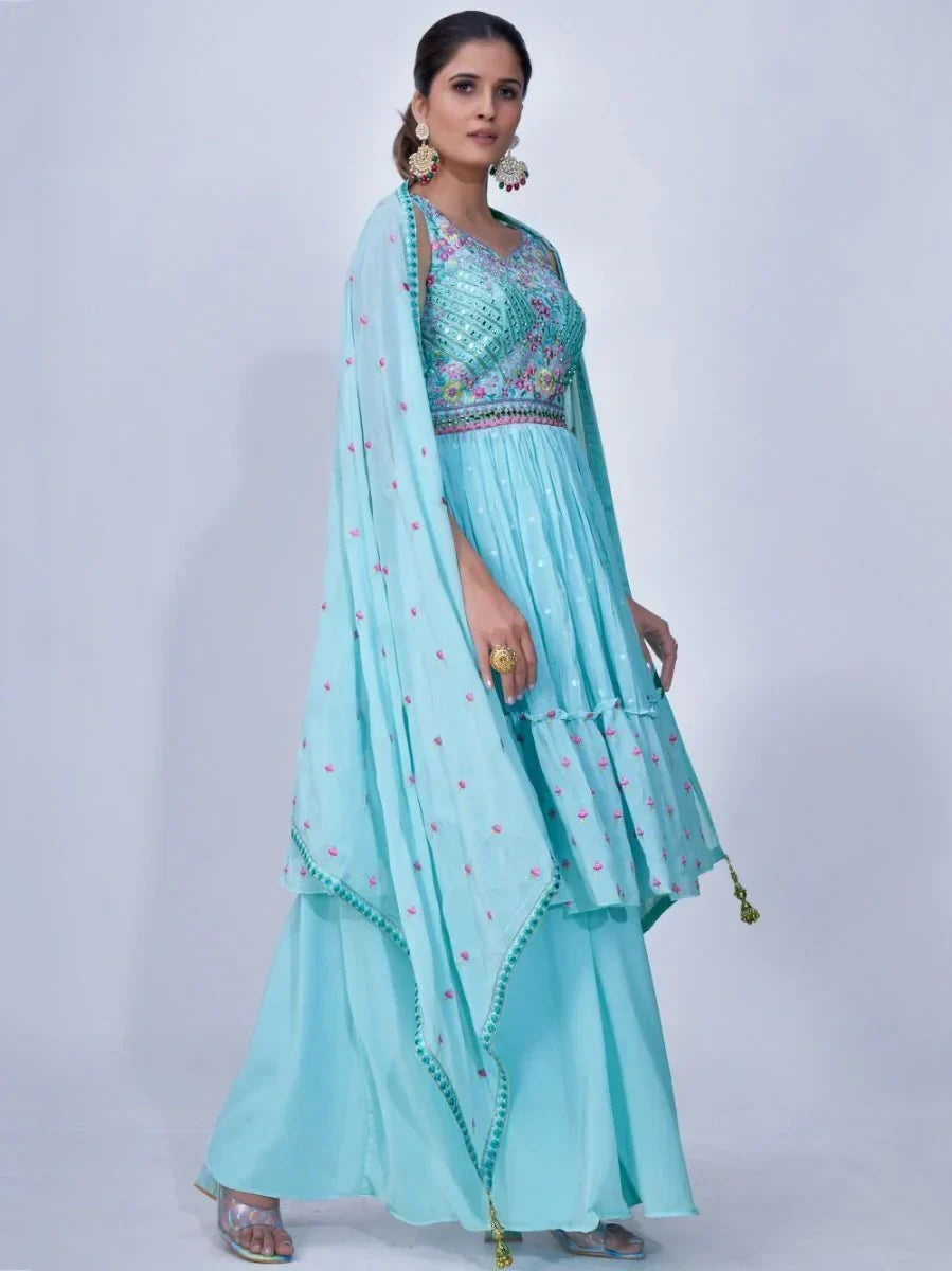 Woman wearing light blue embroidered lehenga choli with dupatta, traditional Indian attire