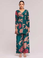 Woman in green and pink floral ethnic palazzo suit, Indian designer wear from Ethnic Plus