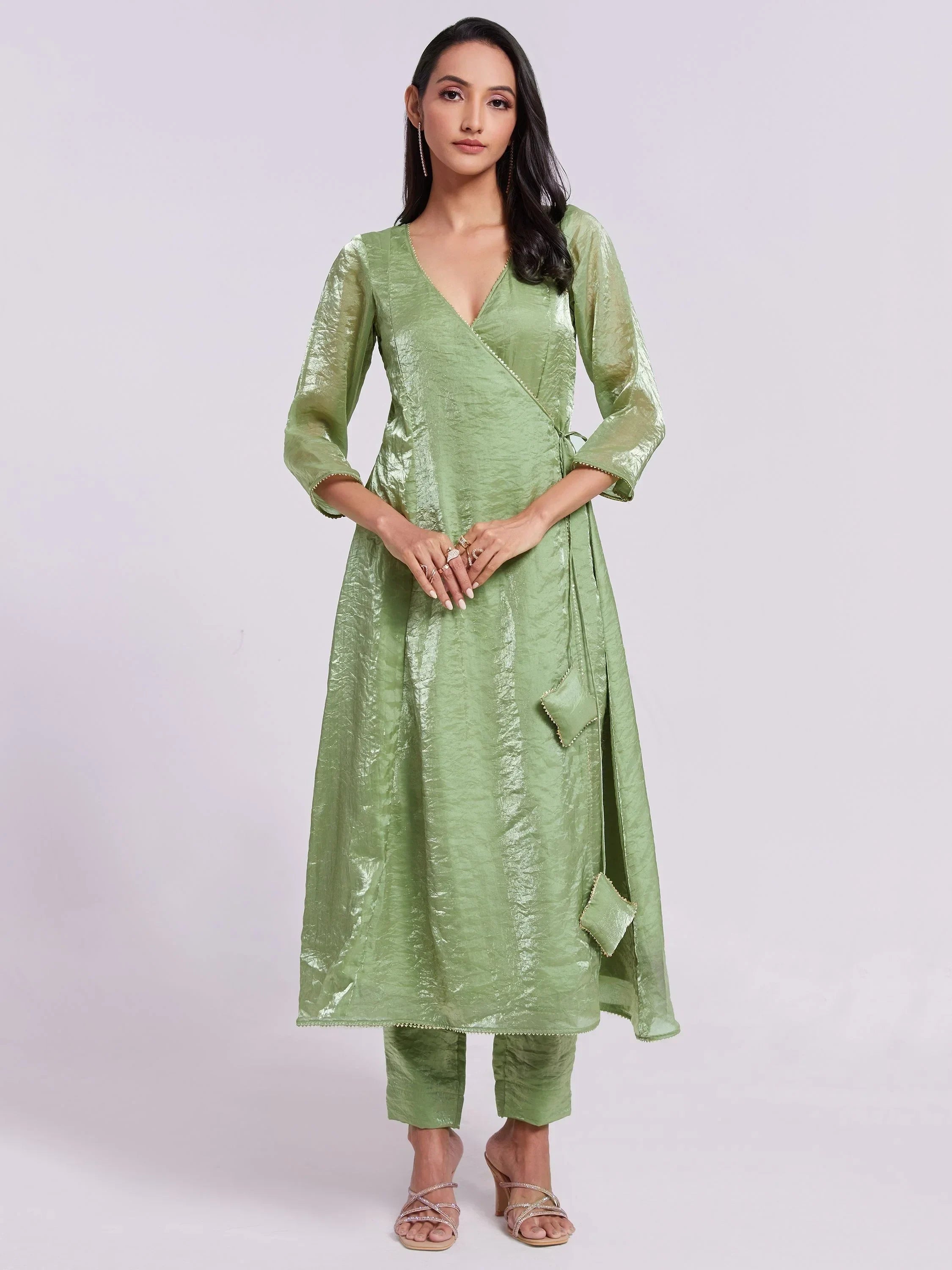 Woman in light green silk wrap kurta set with three-quarter sleeves and straight pants