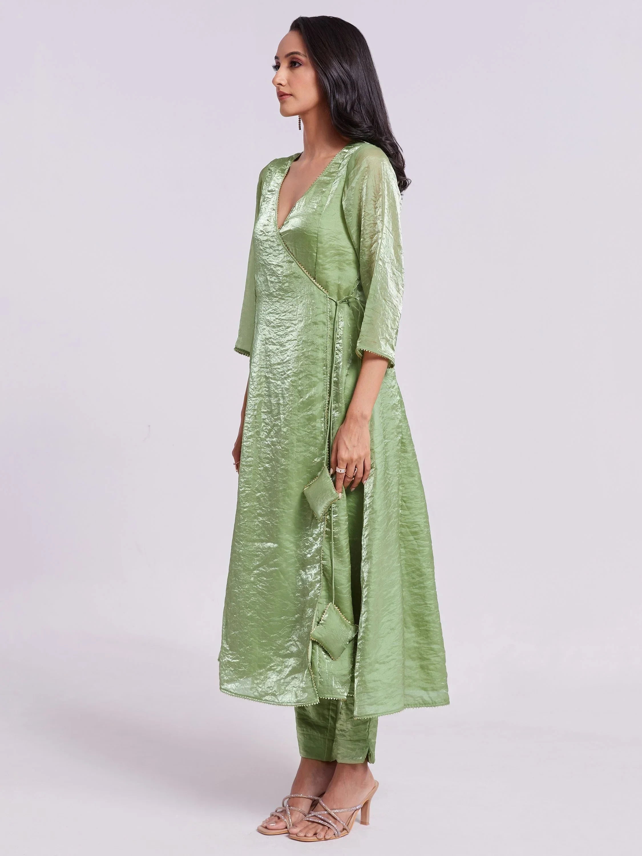 Woman wearing a light green ethnic kurta set with three-quarter sleeves and matching pants