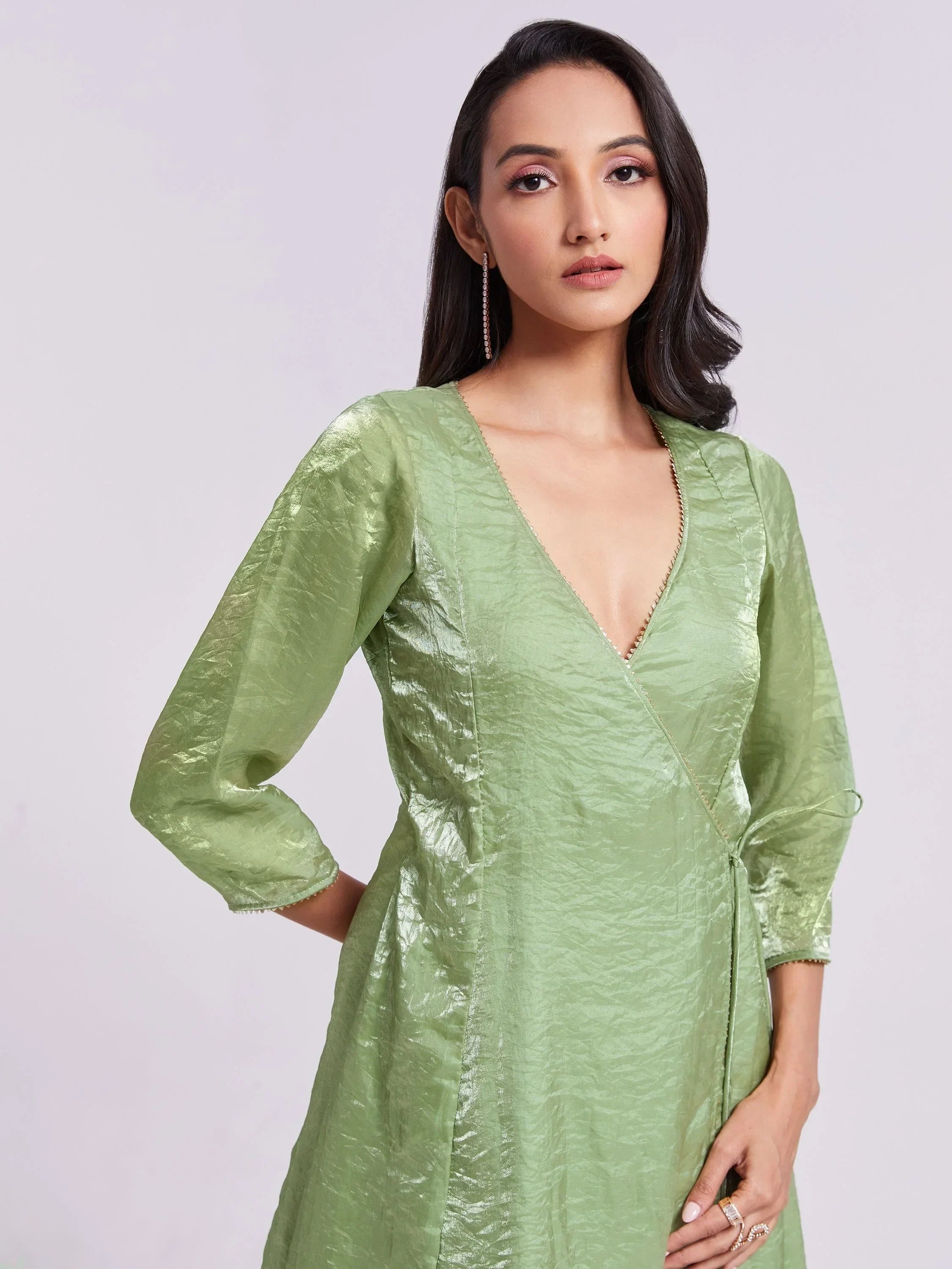 Woman wearing light green ethnic gown with V-neck and three-quarter sleeves