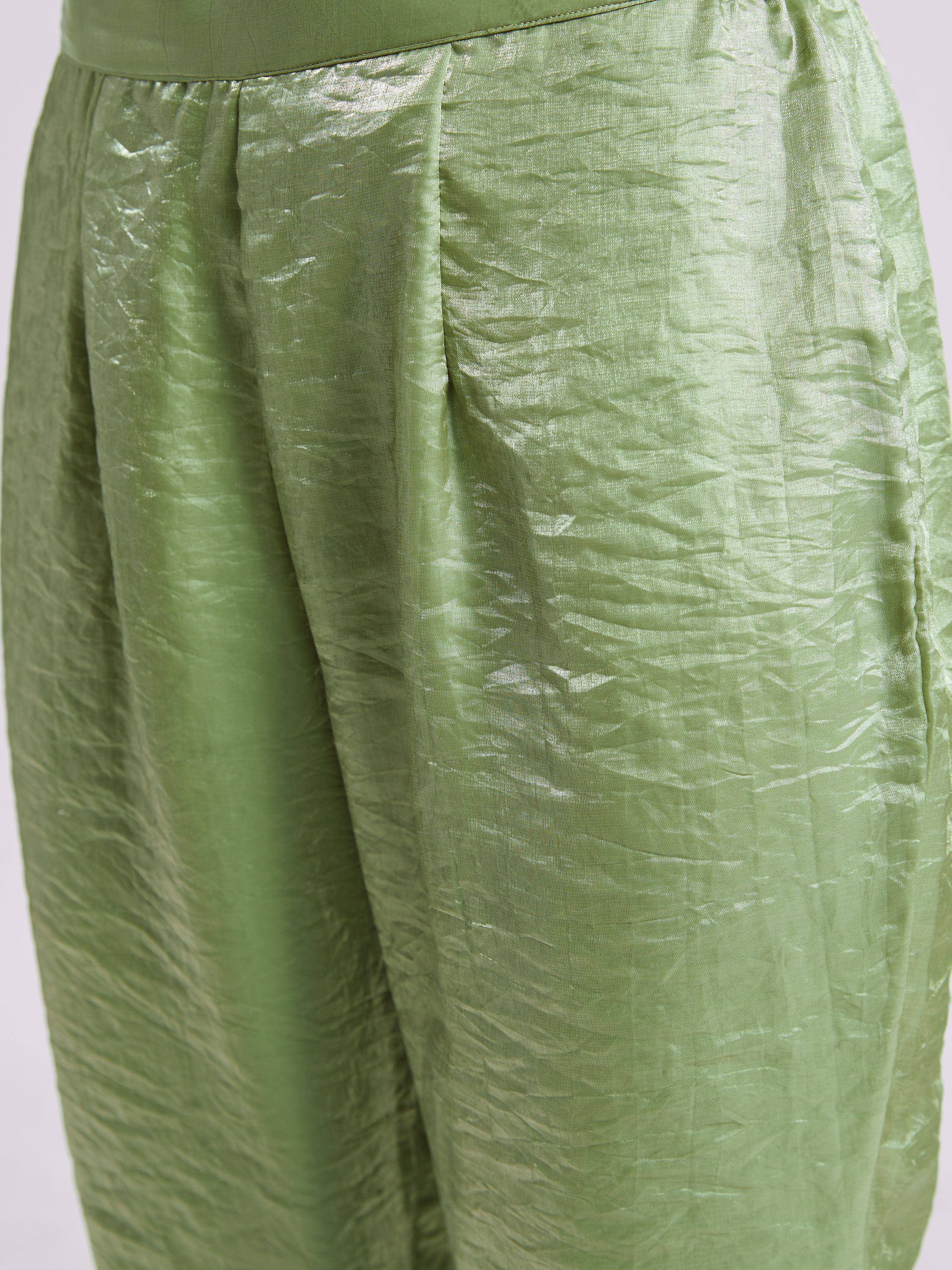 Olive green ethnic palazzo pants with pleated waist, crinkled texture, and satin finish for festive wear.