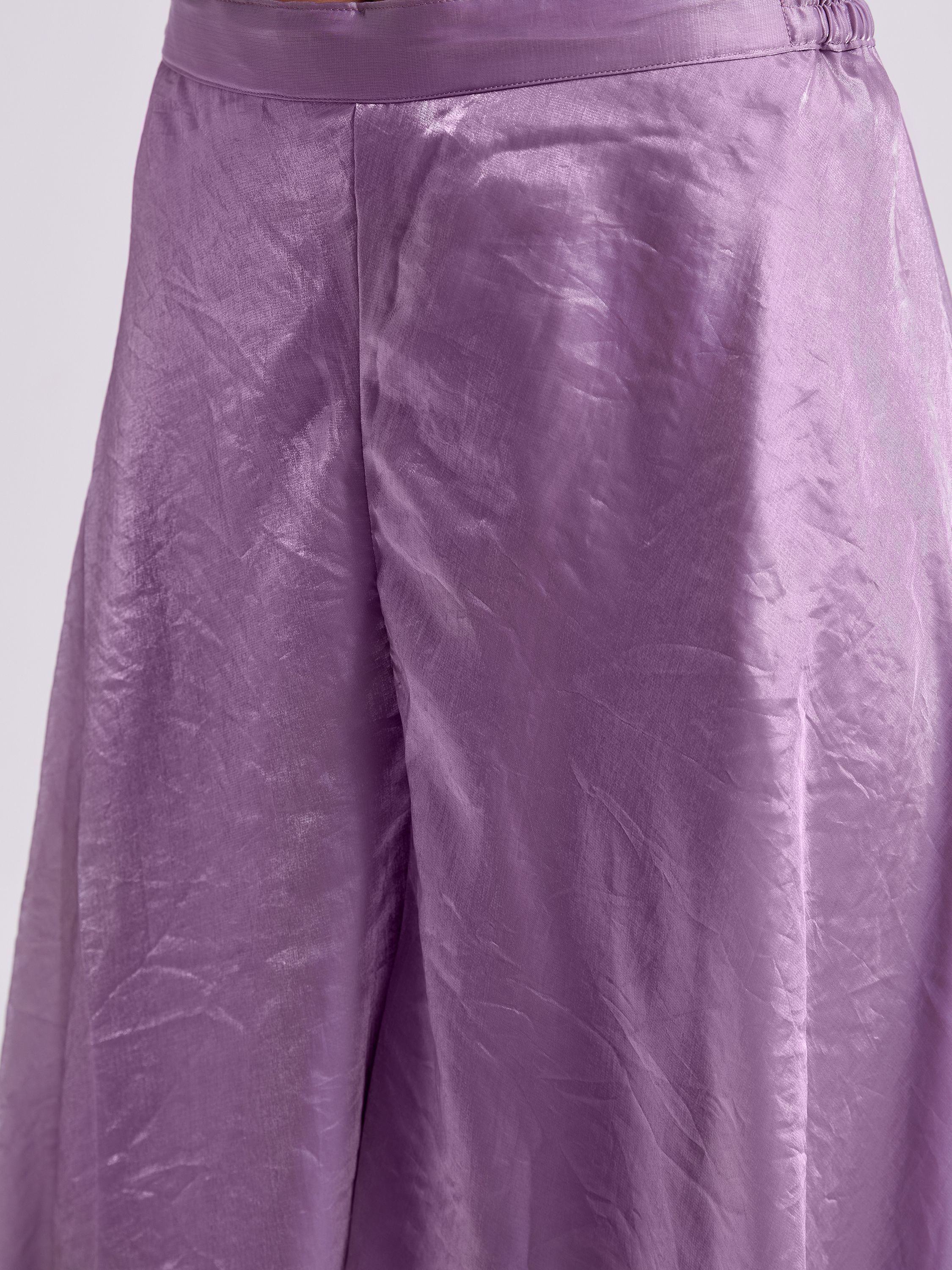 Close-up of a shiny lavender silk lehenga skirt with smooth texture