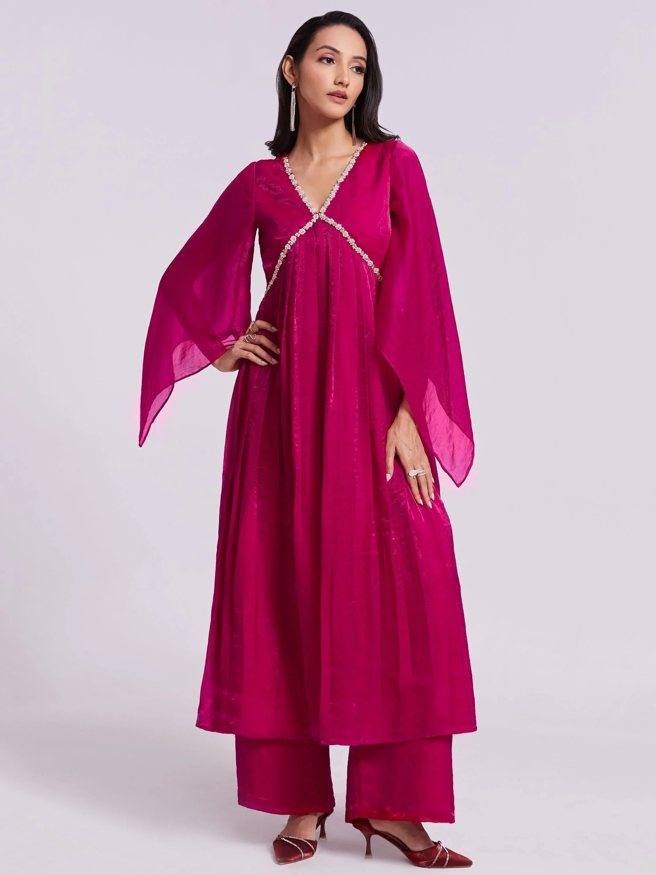 Woman wearing magenta flared kurta with palazzo pants, ethnic Indian party wear outfit