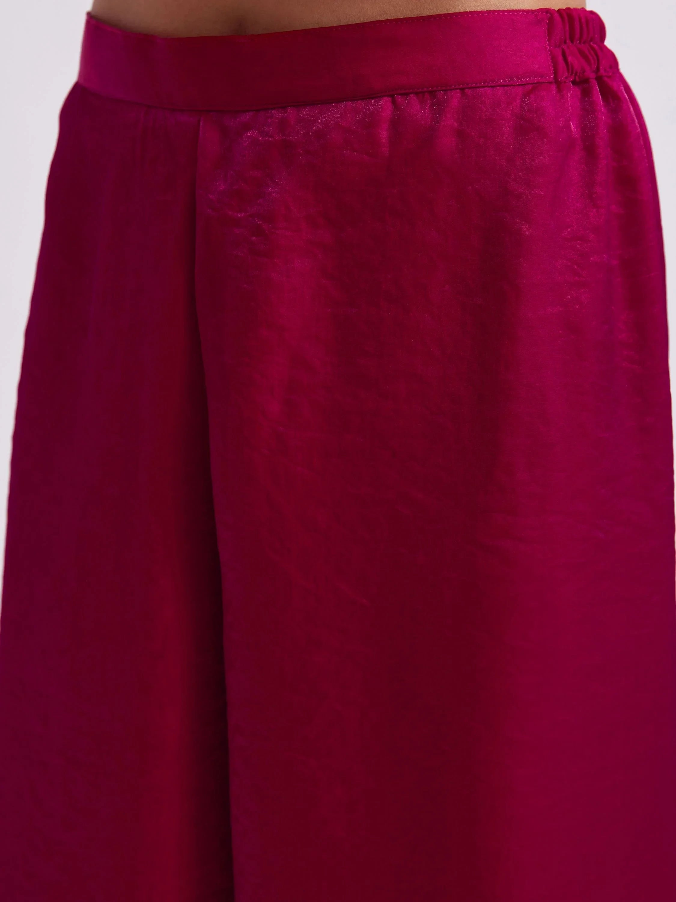 Close-up of magenta silk palazzo pants with elastic waistband, Indian ethnic wear.