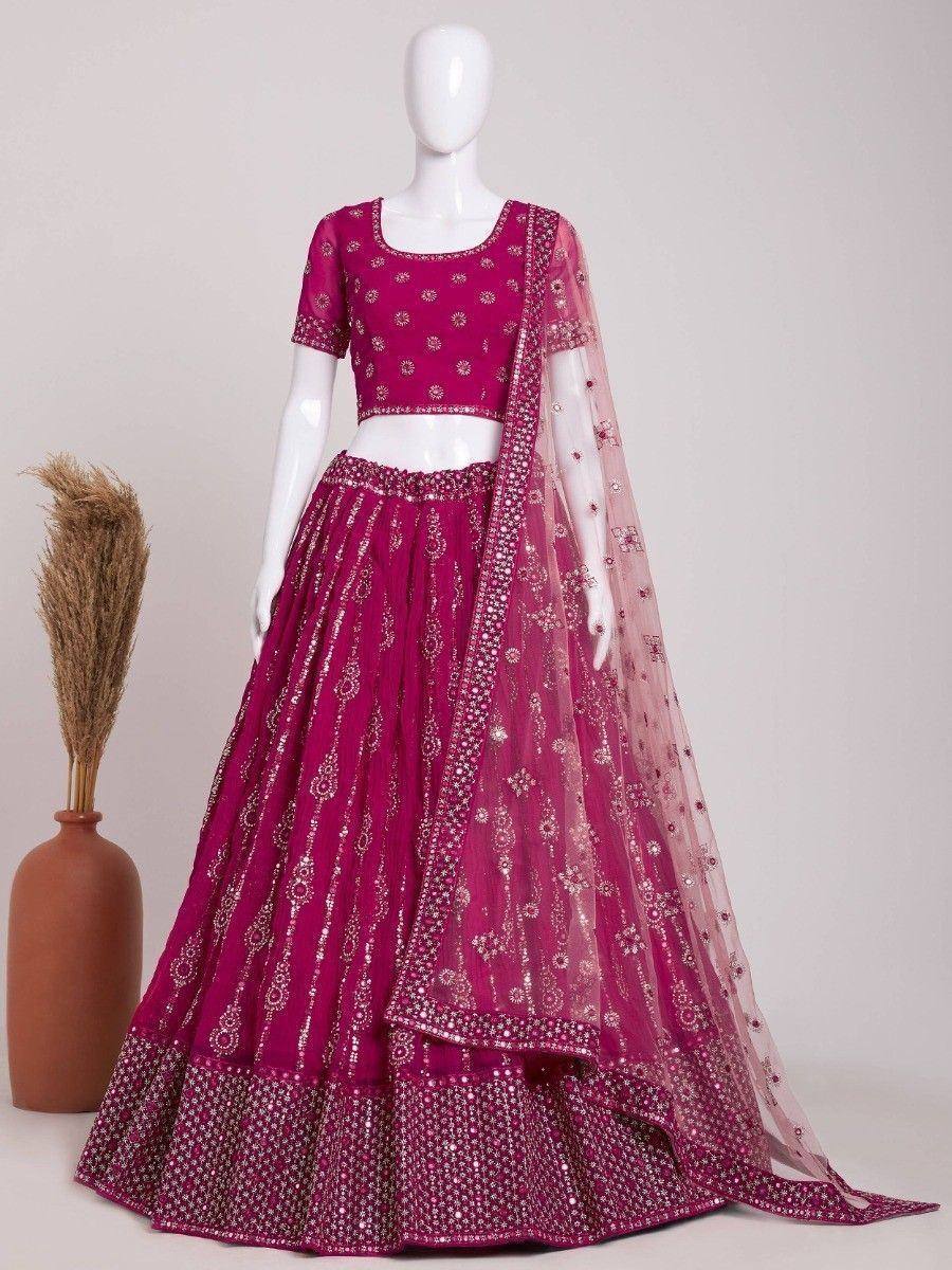 Fuchsia designer lehenga choli with gold embroidery and sheer dupatta, perfect for Indian ethnic wear occasions
