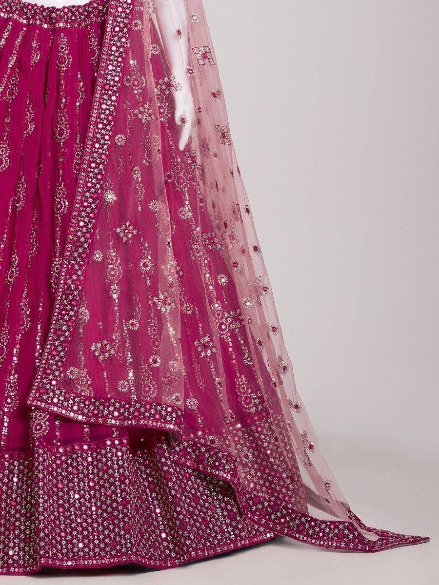 Fuchsia designer lehenga choli with intricate silver embroidery and sheer dupatta, perfect for Indian ethnic wear.