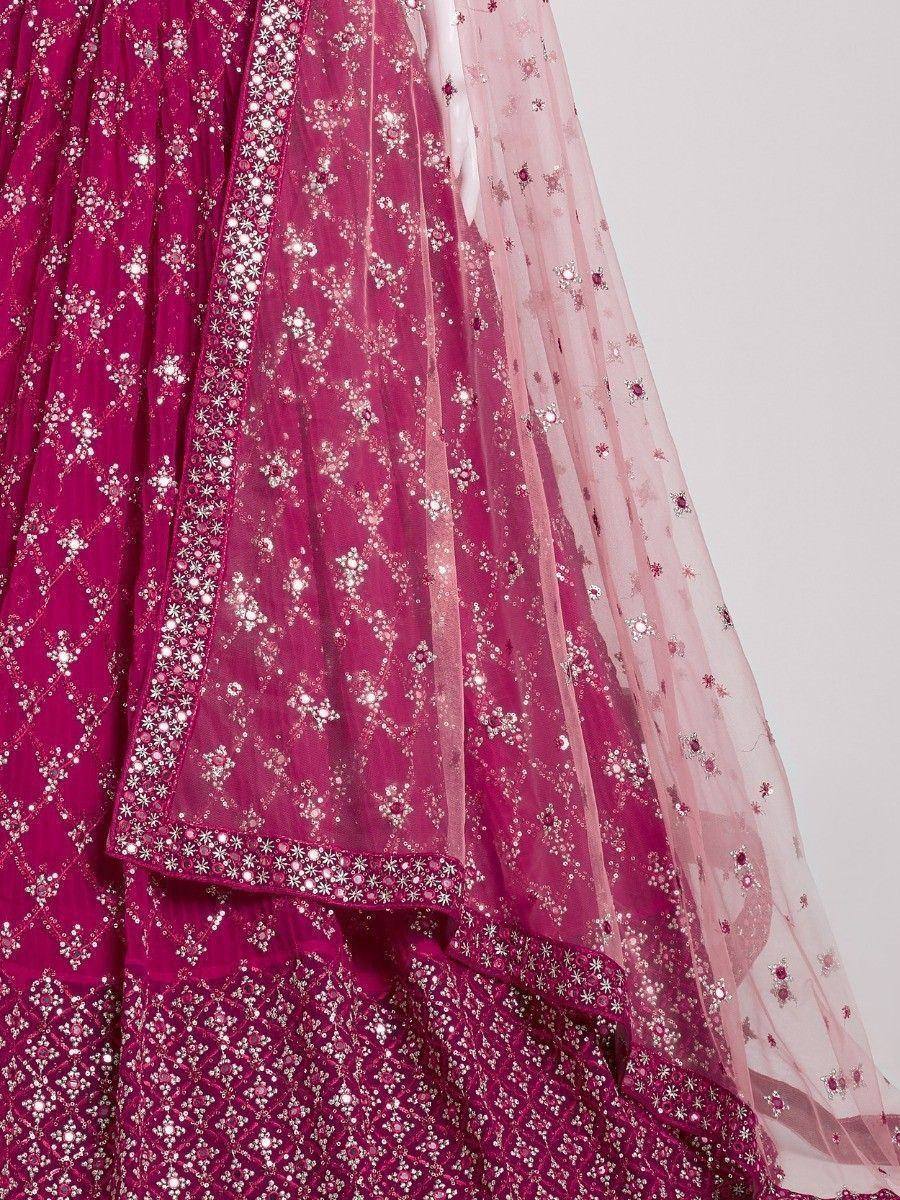 Fuchsia designer lehenga choli with intricate silver embroidery and sheer dupatta, perfect for Indian weddings