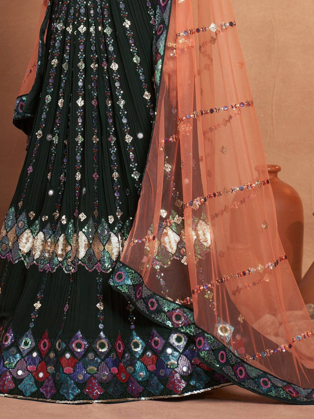 Dark green pleated lehenga with colorful sequin embroidery and peach net dupatta, Indian ethnic wear