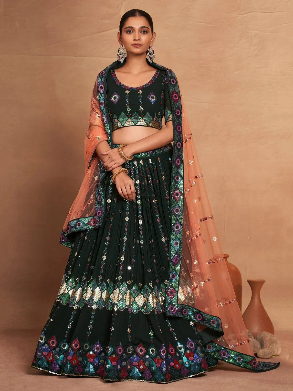 Dark green embroidered lehenga choli with peach dupatta, perfect for Indian ethnic wear and festive occasions.