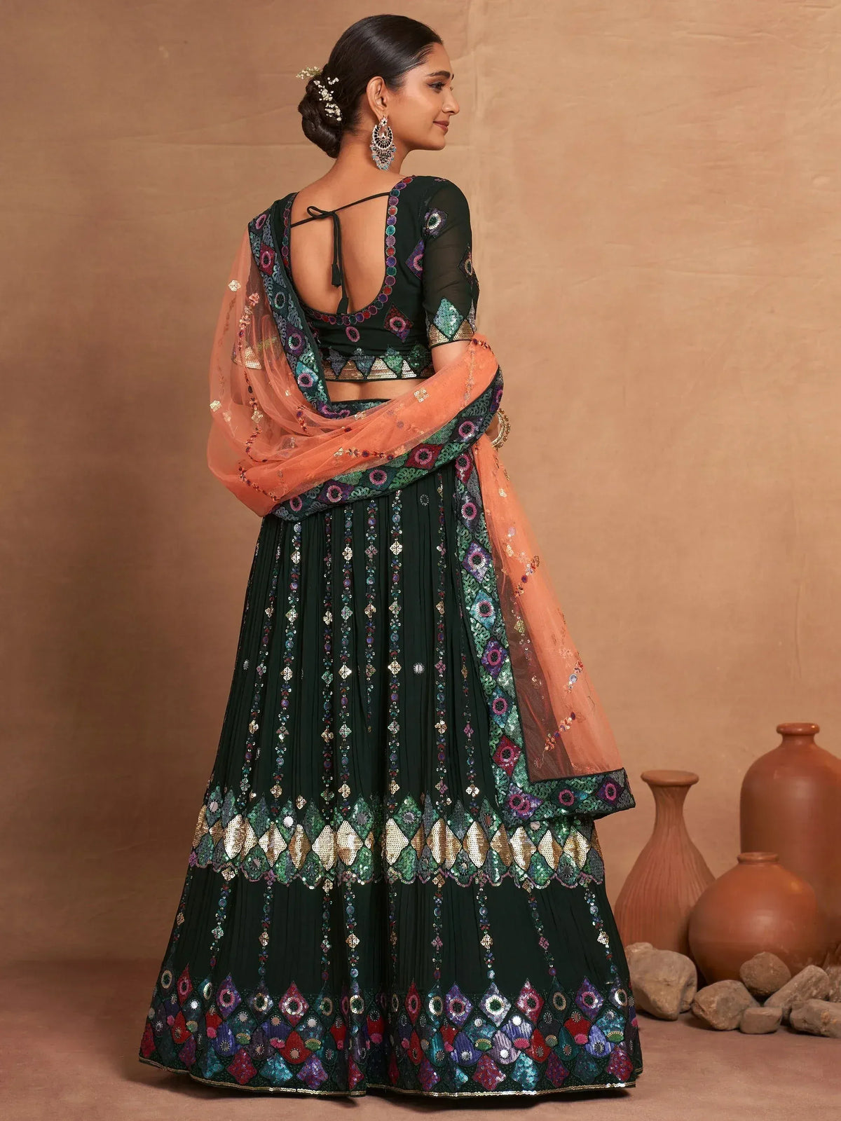 Emerald green lehenga choli with mirror work and peach dupatta, ethnic Indian wear