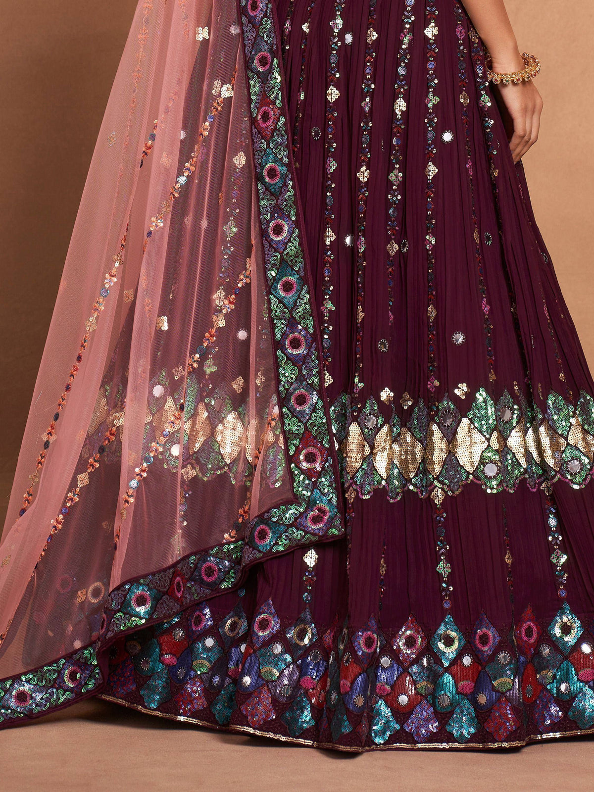 Elegant maroon lehenga choli with colorful sequin embroidery and sheer dupatta, perfect for Indian ethnic wear.