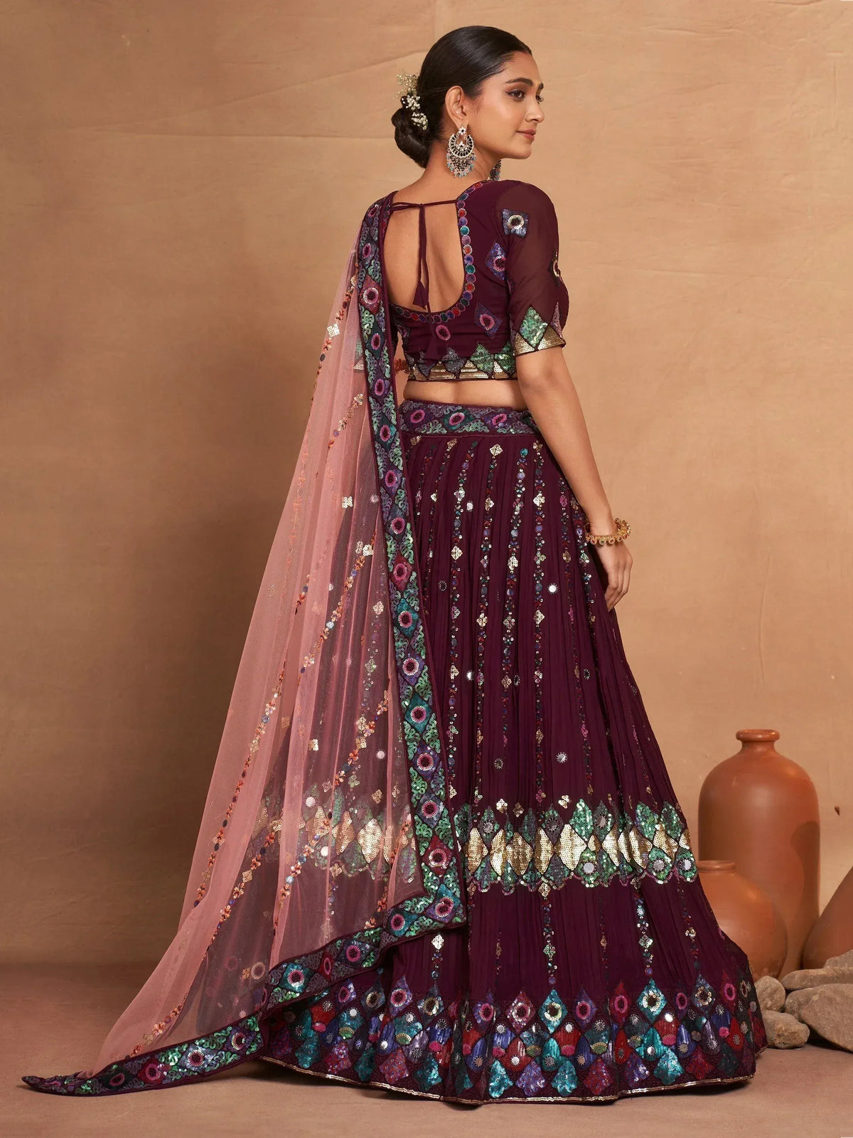 Elegant maroon lehenga choli with mirror work, sequins, and sheer dupatta for Indian ethnic wear