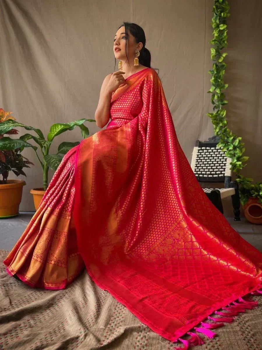 Red and gold designer saree with intricate patterns and tassels, perfect for ethnic occasions