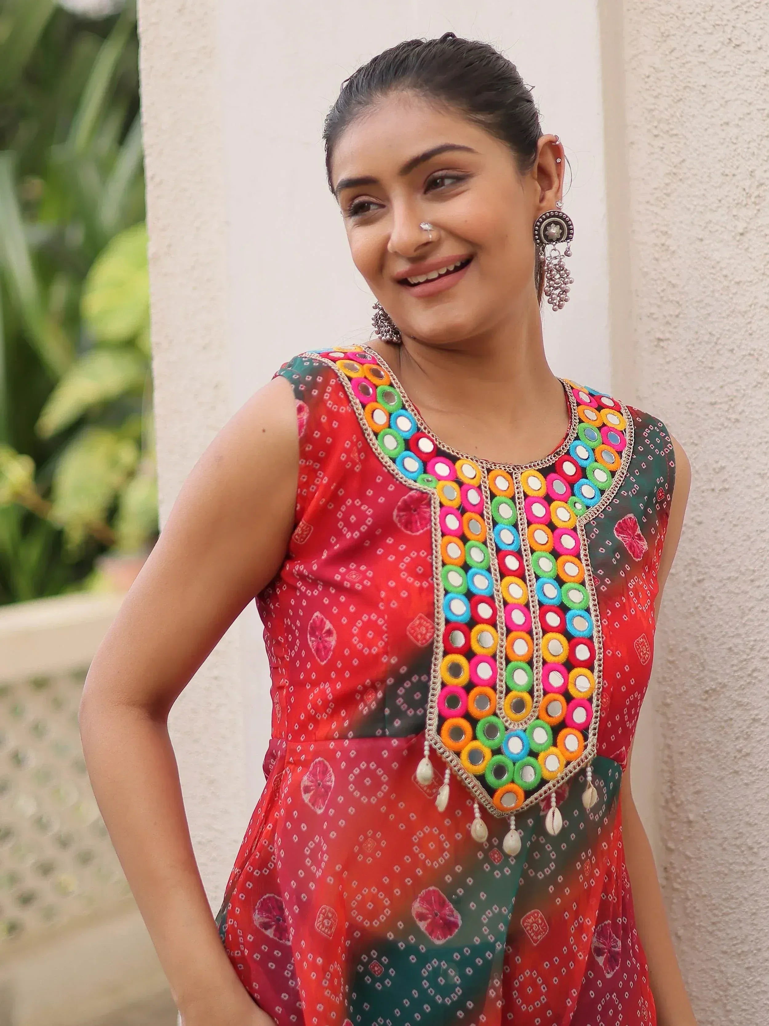 Woman in colorful mirror-work ethnic kurta with floral print, perfect for Indian festive wear