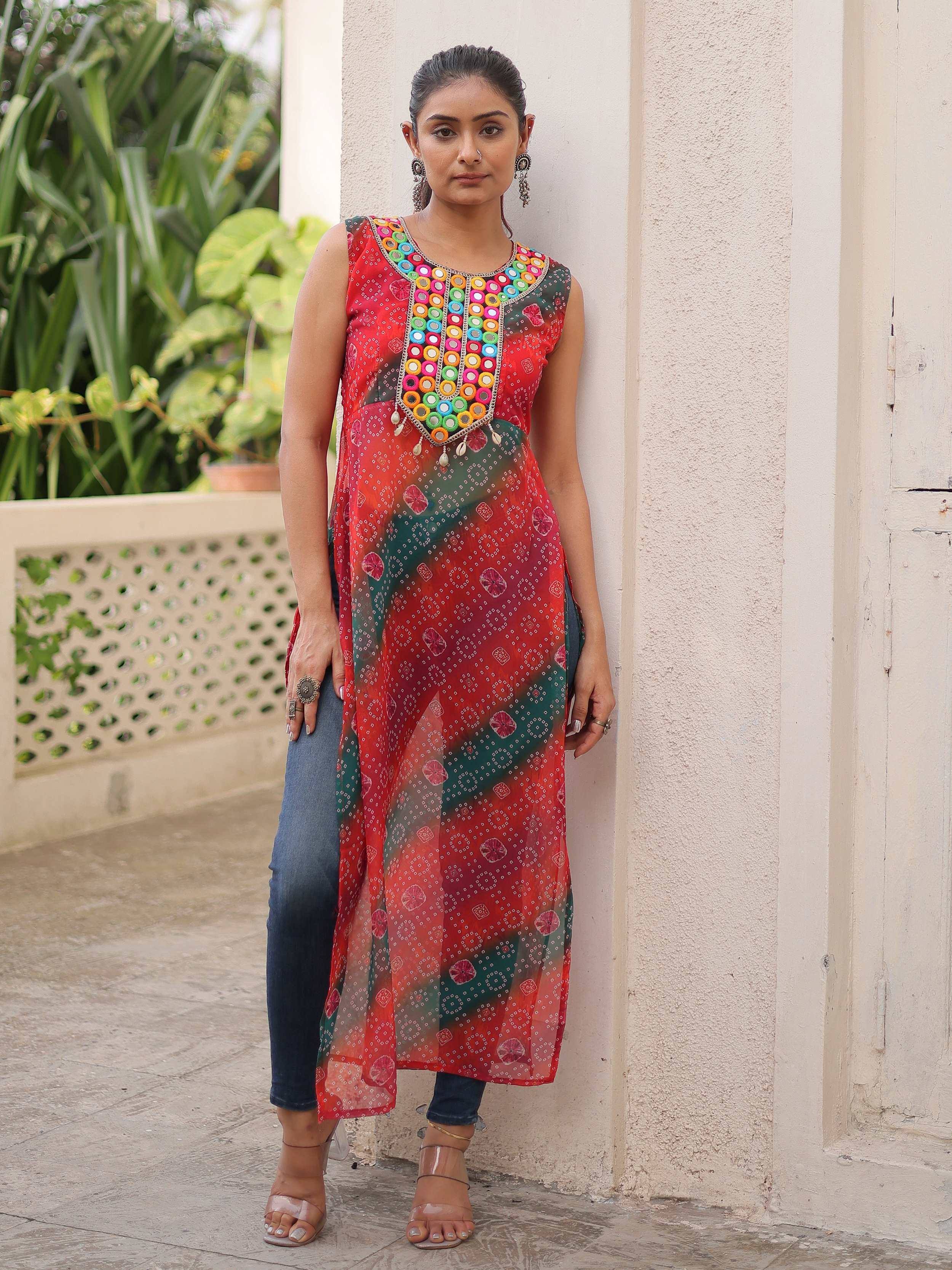 Colorful mirror-work ethnic kurta with bandhani print, paired with jeans for a fusion look