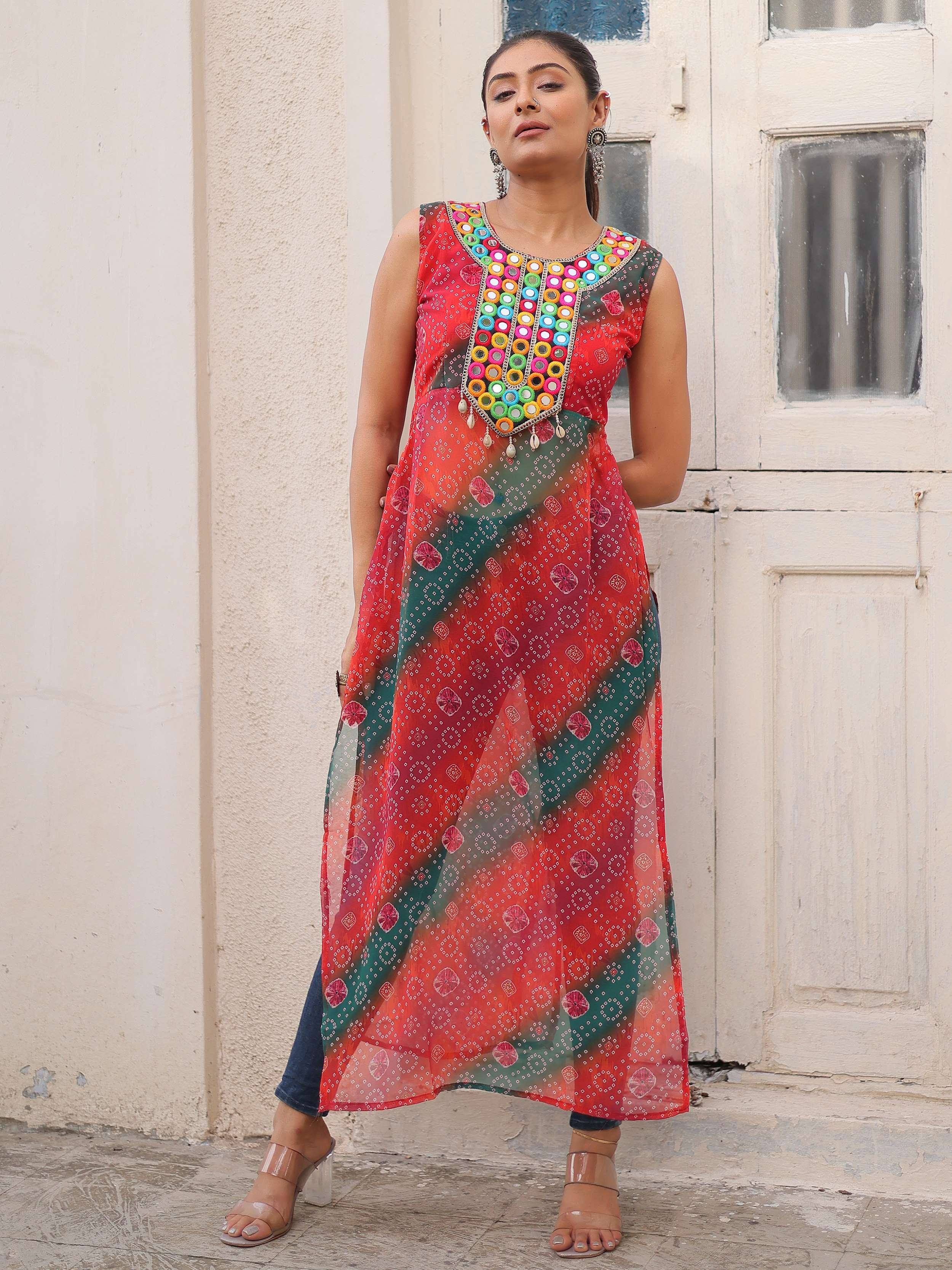 Red and green ethnic gown with mirror work, perfect for Indian festive wear and designer occasions.