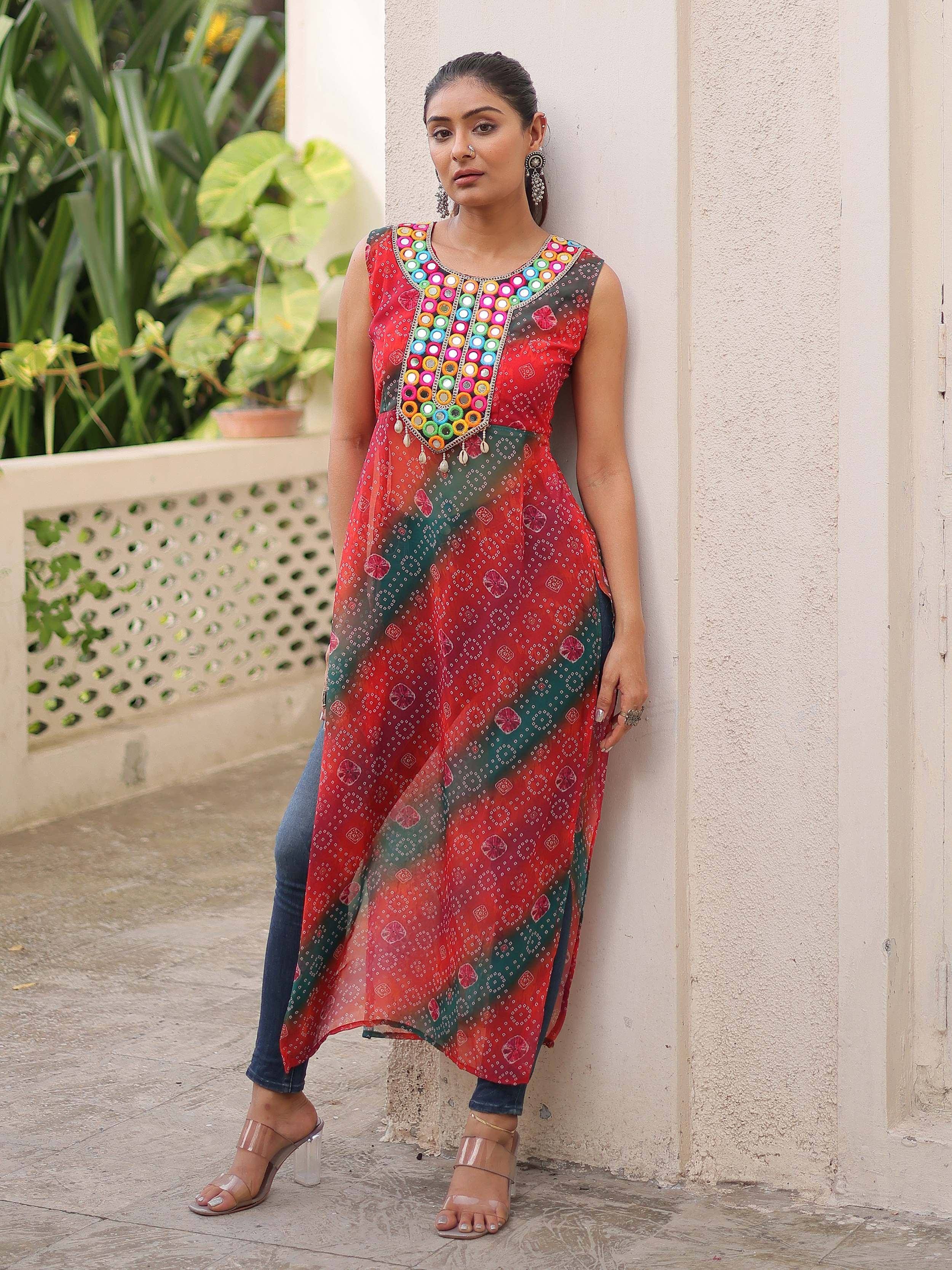 Red and green ethnic kurti with mirror work, paired with jeans for casual Indian wear