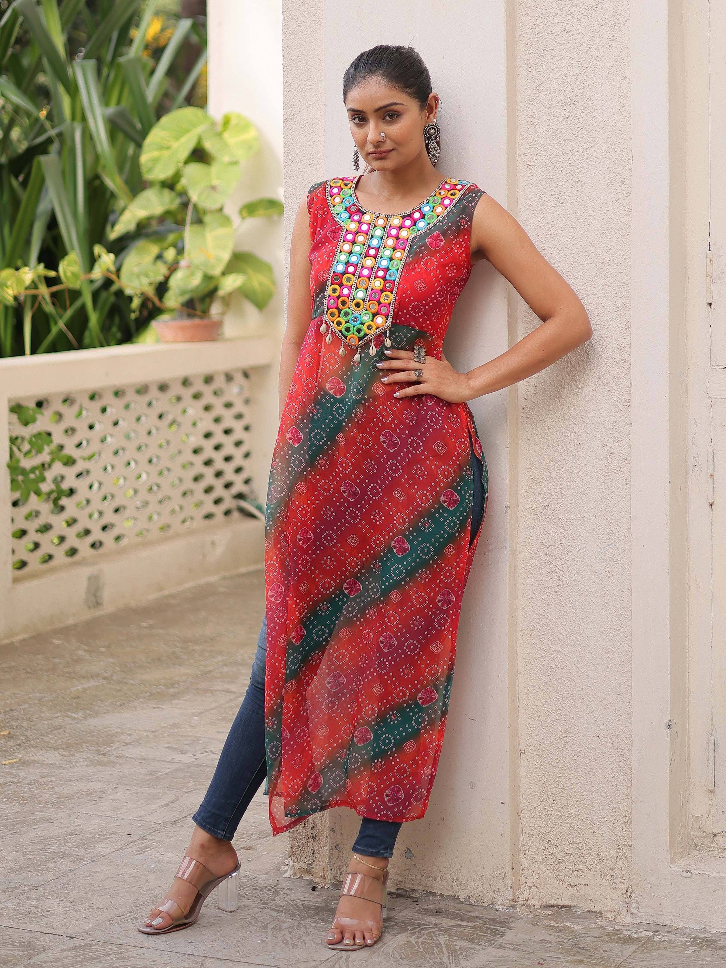 Woman in colorful mirror-work ethnic kurta with bandhani print, styled with jeans and heels