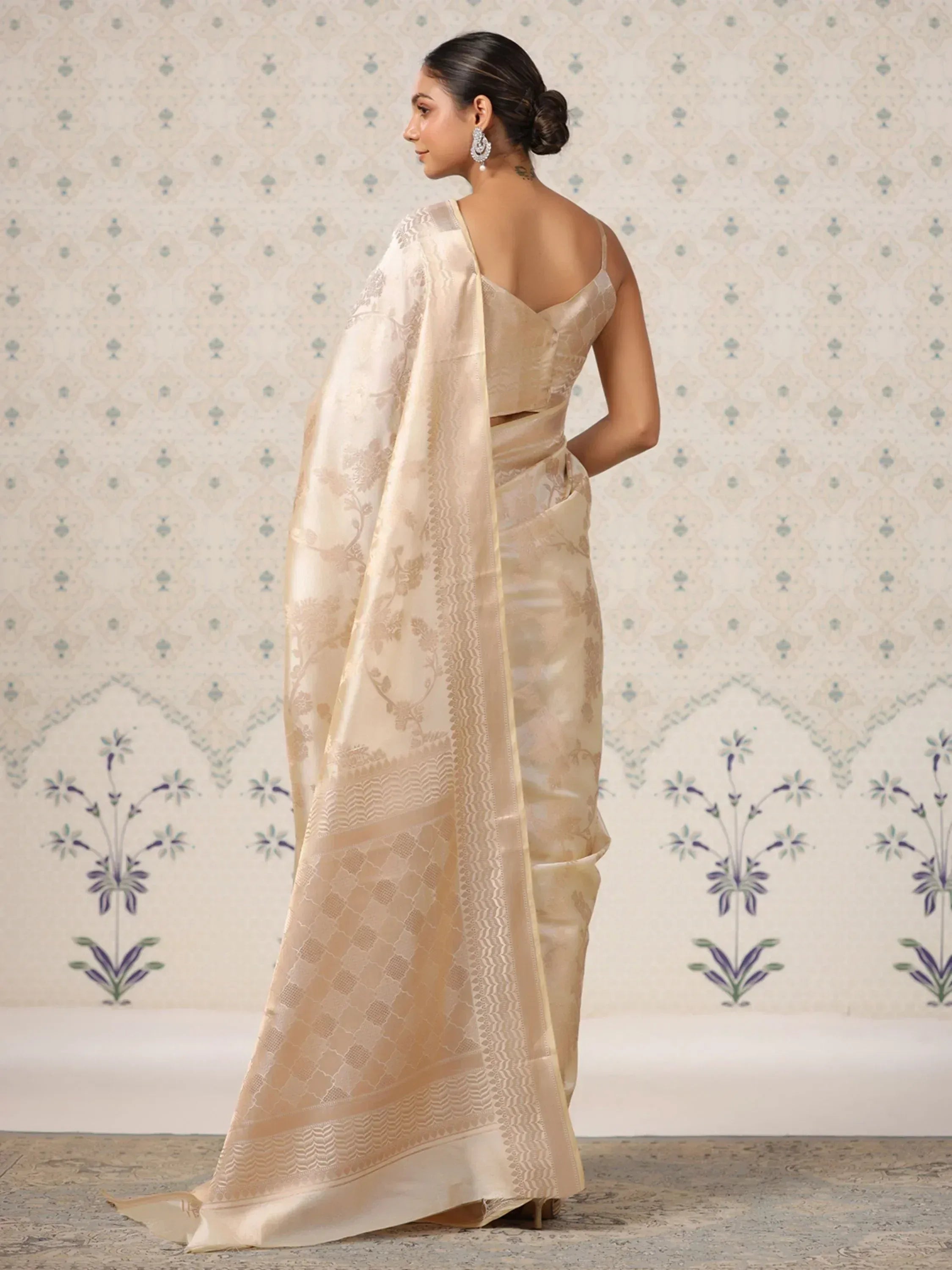 Elegant beige designer saree with floral jacquard and border, perfect for Indian ethnic wear occasions.