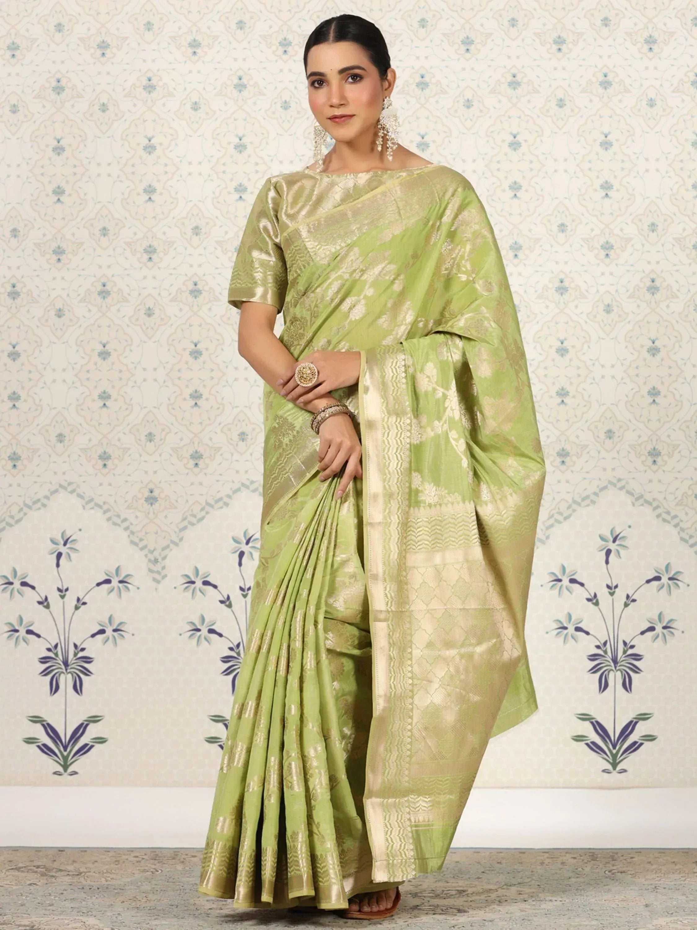 Elegant green saree with gold zari work, perfect for Indian ethnic wear occasions.