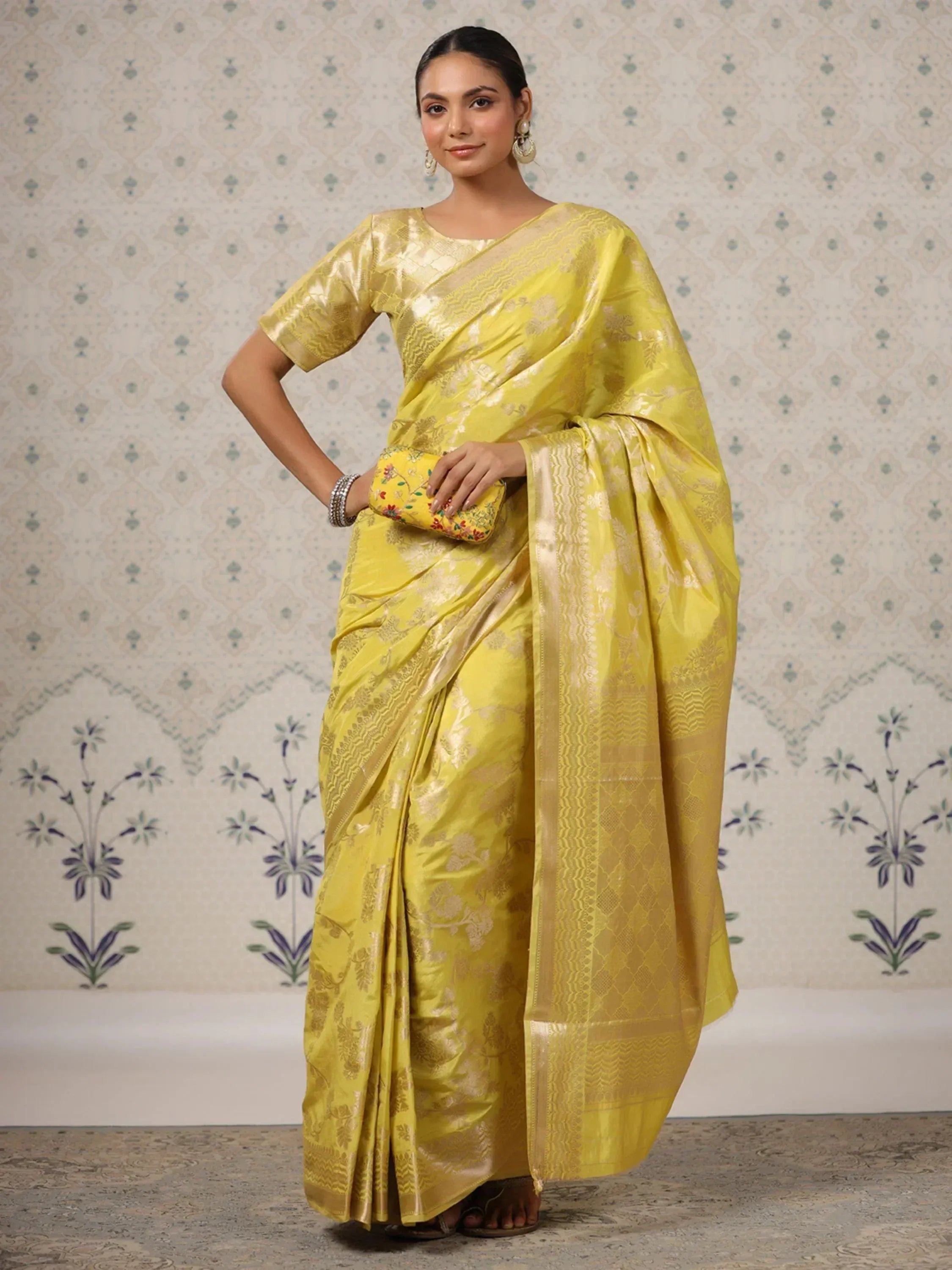 Yellow designer saree with gold floral patterns, perfect for ethnic occasions