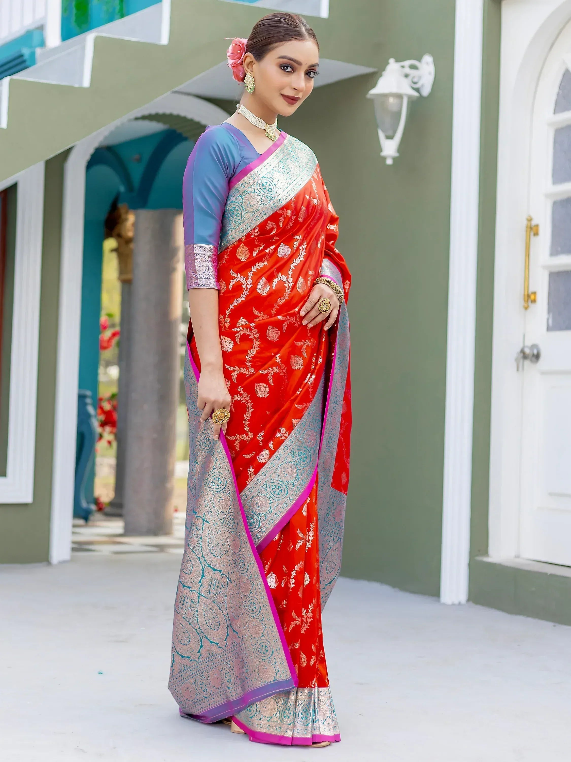Red floral print saree with blue blouse and silver border, perfect for Indian ethnic occasions