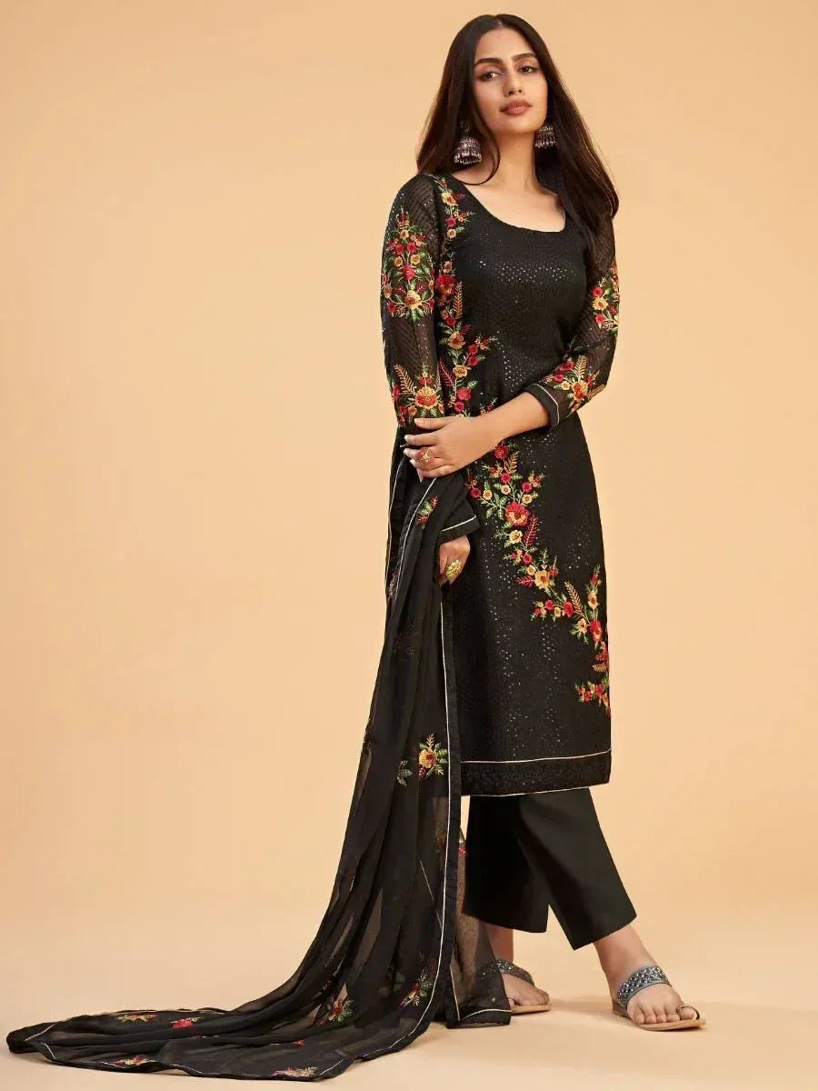 Woman wearing black embroidered salwar kameez with floral design and matching dupatta
