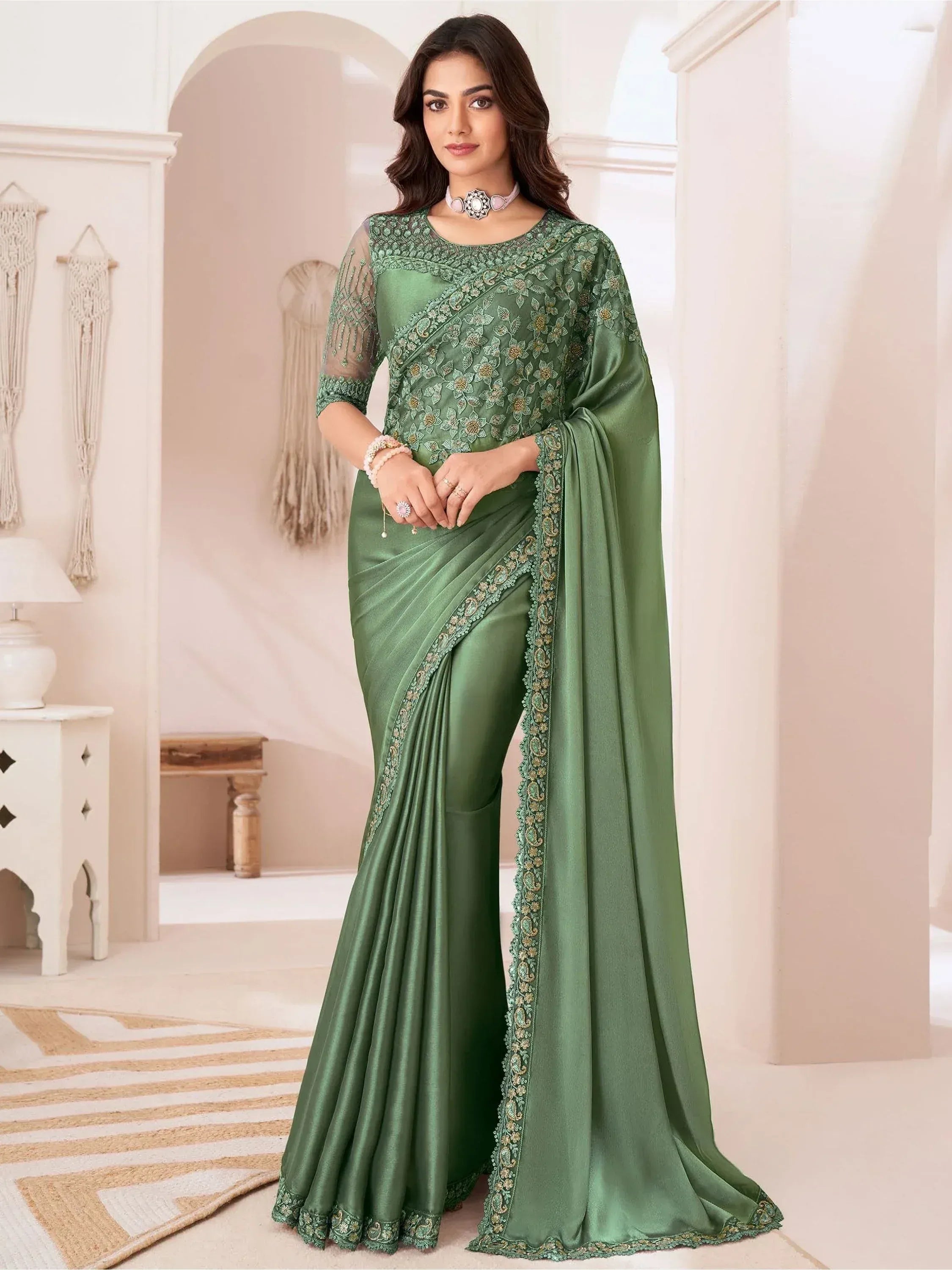 Emerald green designer saree with floral embroidery and sheer sleeves, perfect for Indian ethnic occasions.