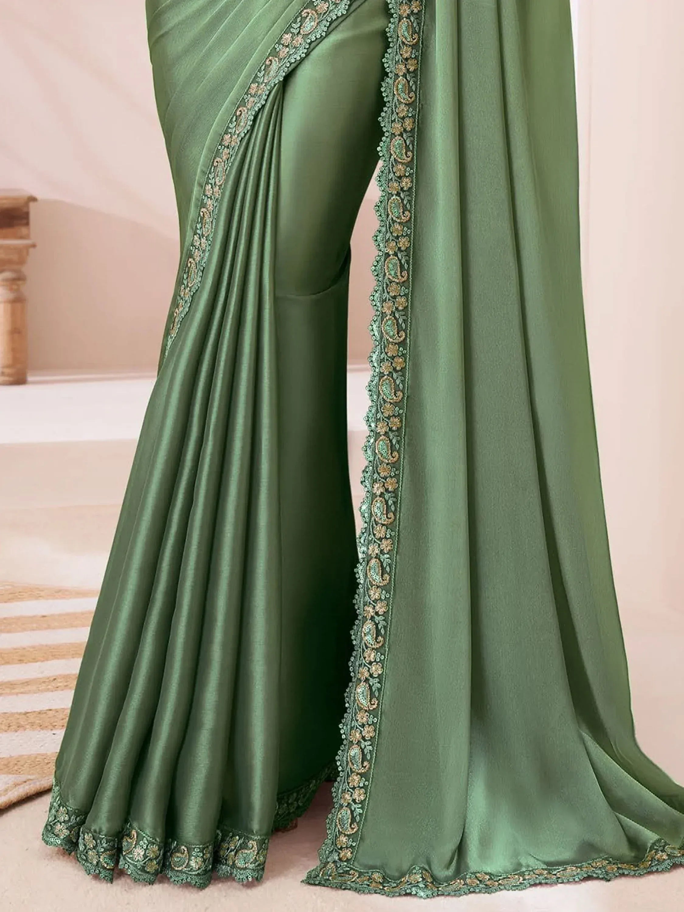 Green satin saree with gold paisley embroidery, elegant Indian ethnic wear for women