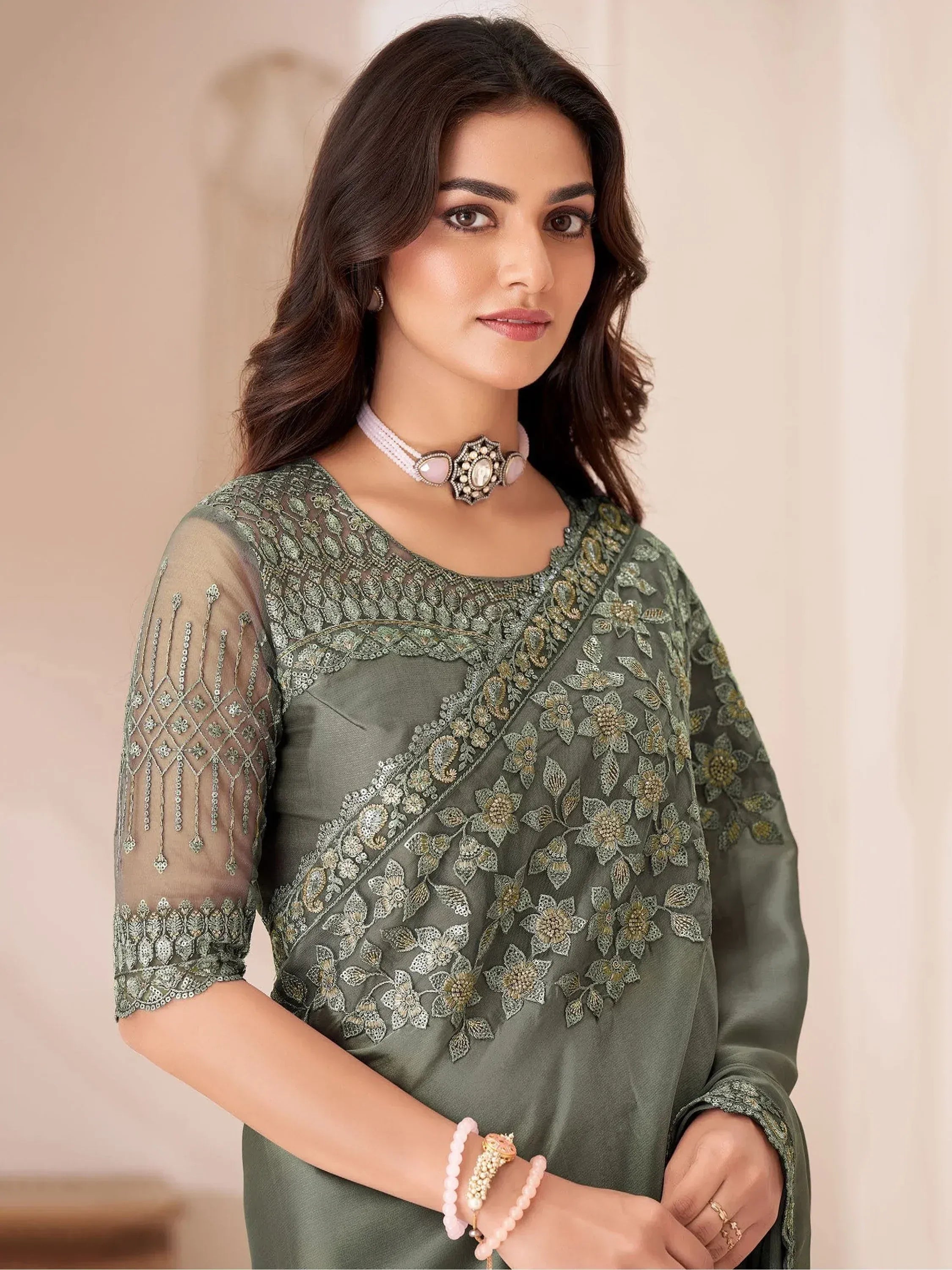 Olive green embroidered ethnic kurti with sheer sleeves, floral zari work, and statement choker for women