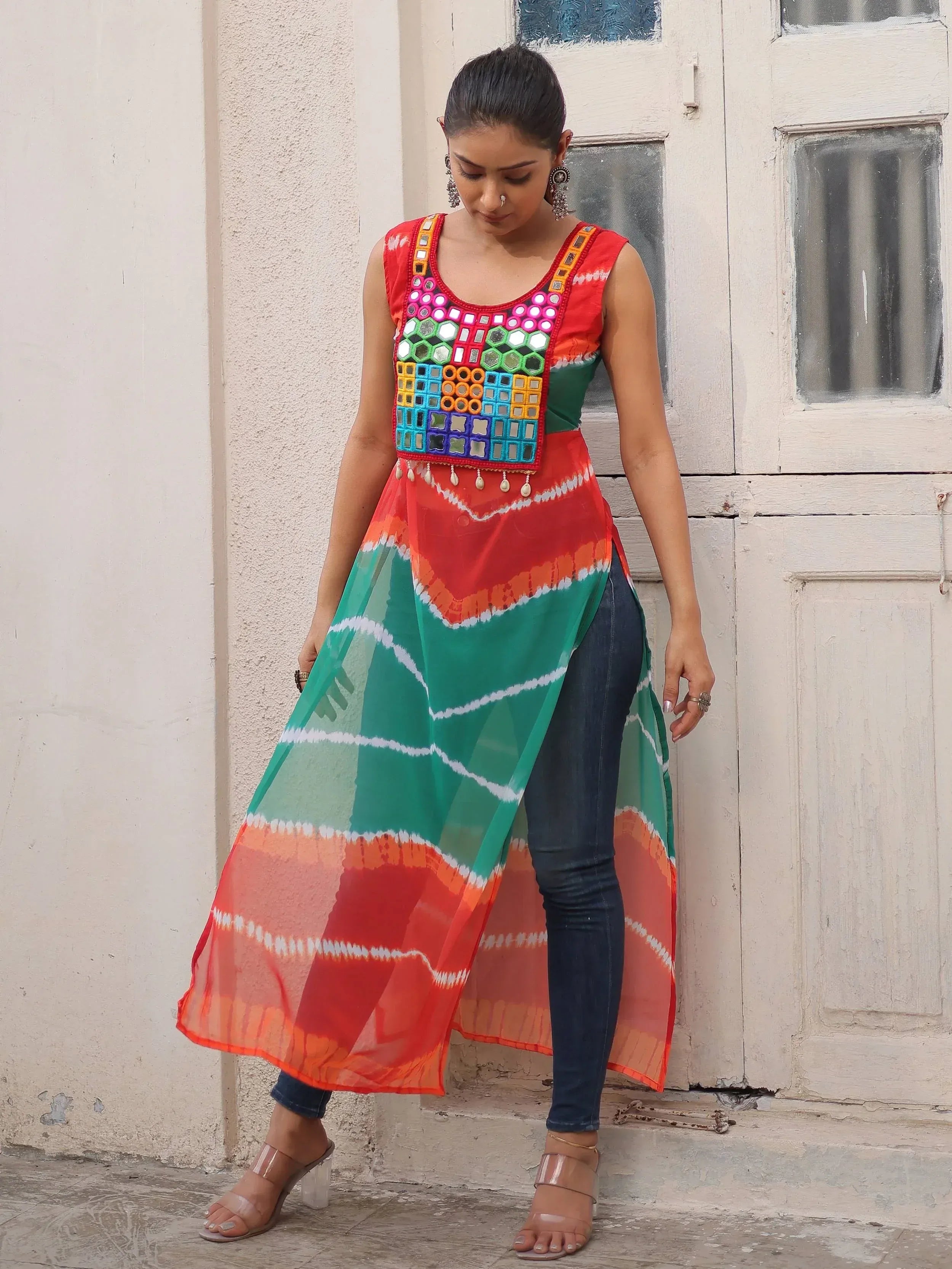 Colorful mirror-work ethnic kurti with tie-dye print, paired with jeans for a fusion look