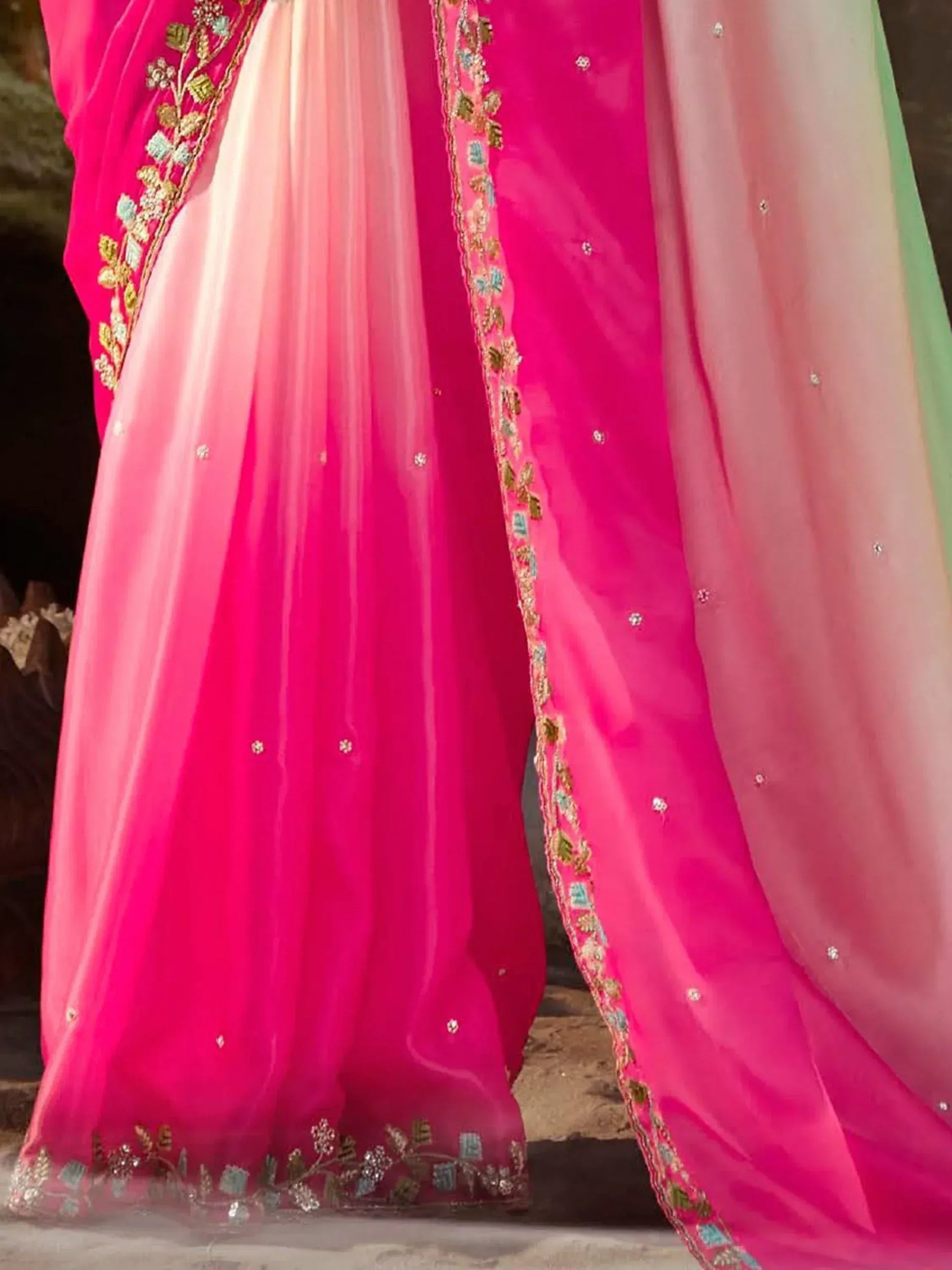 Pink ethnic lehenga choli with gold floral embroidery and sheer dupatta, perfect for Indian weddings and festive occasions.