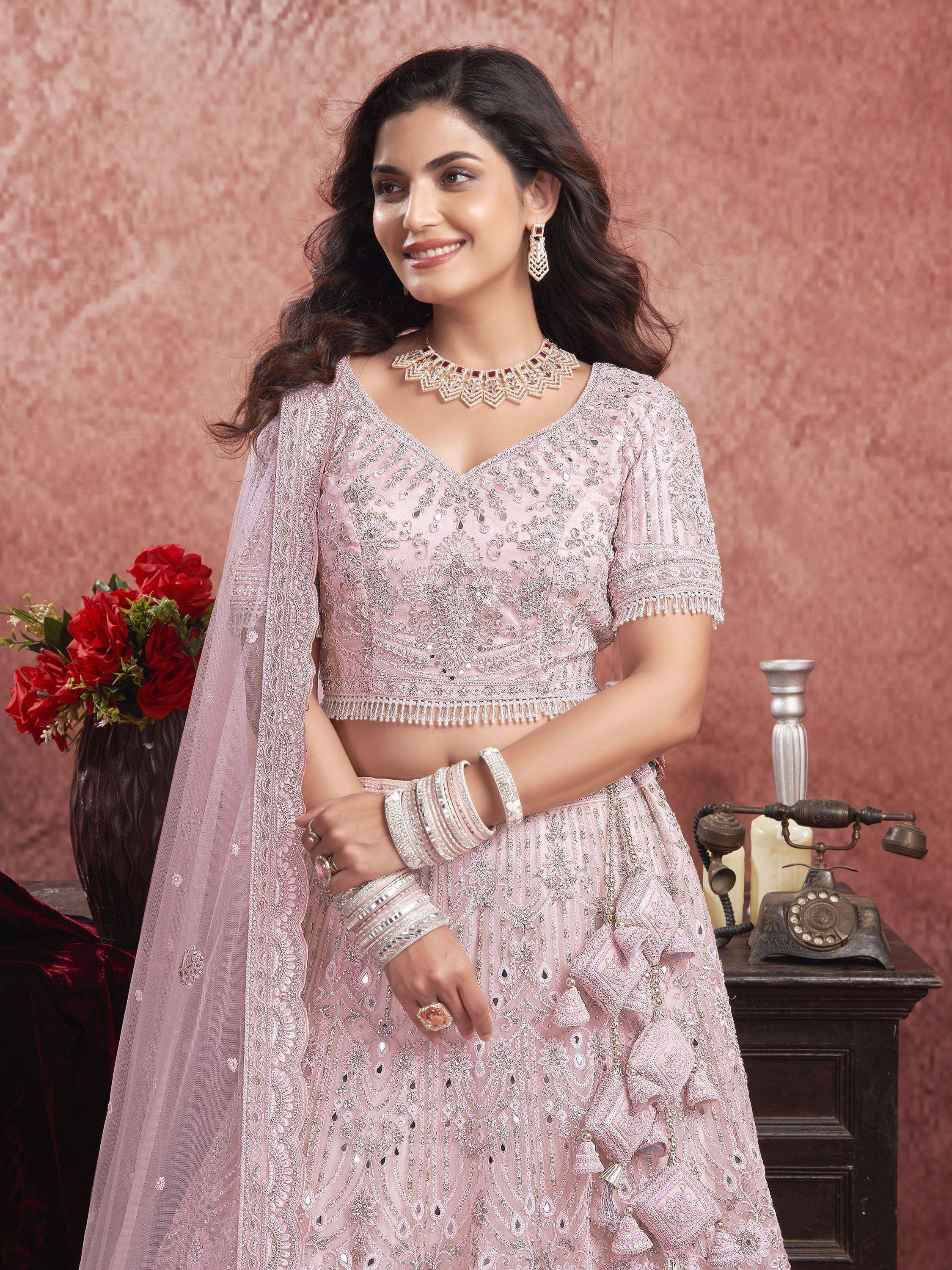 Elegant pink embroidered lehenga choli with intricate detailing and matching dupatta for festive occasions