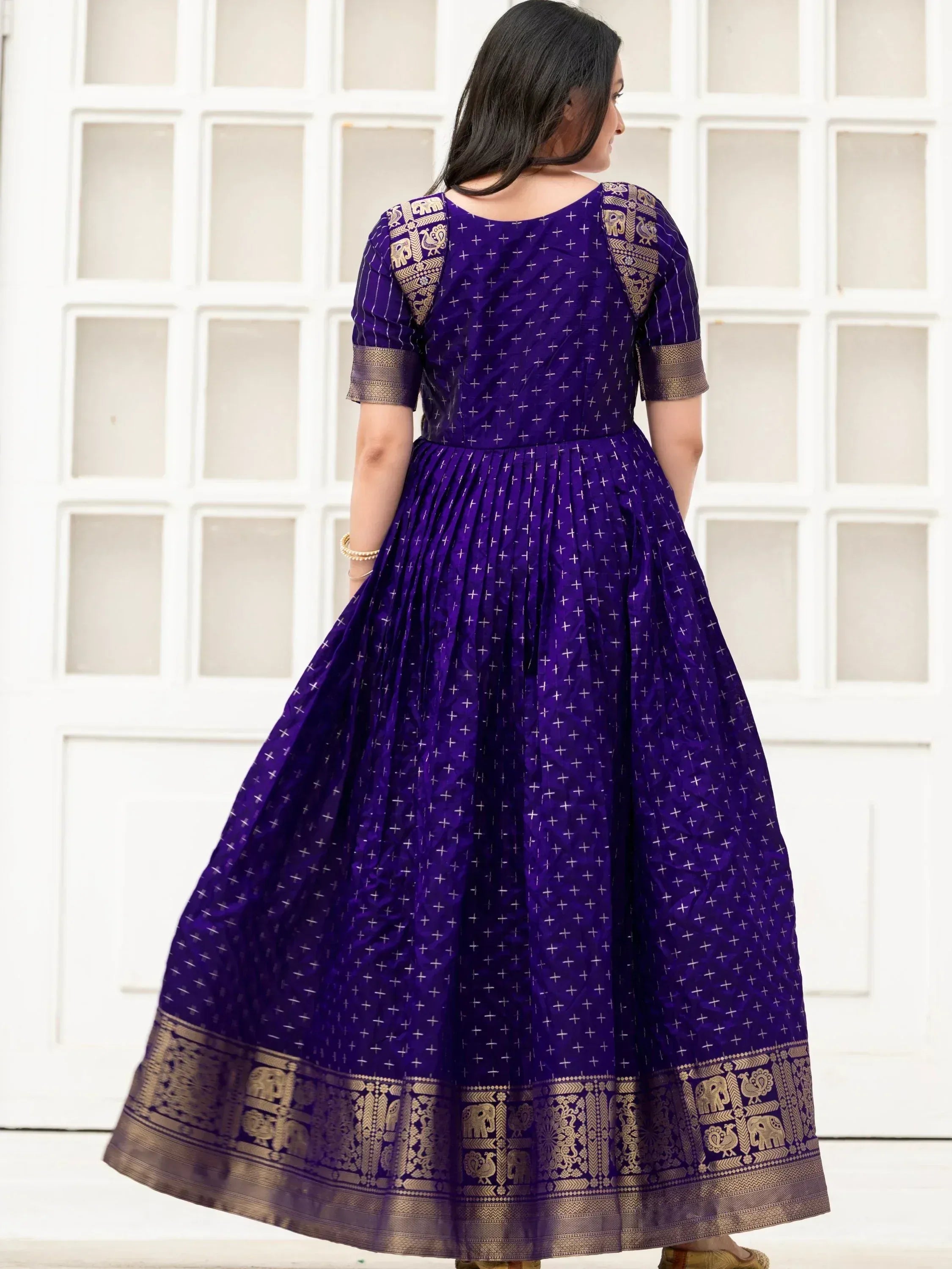 Purple ethnic gown with gold elephant print and border, perfect for Indian occasions