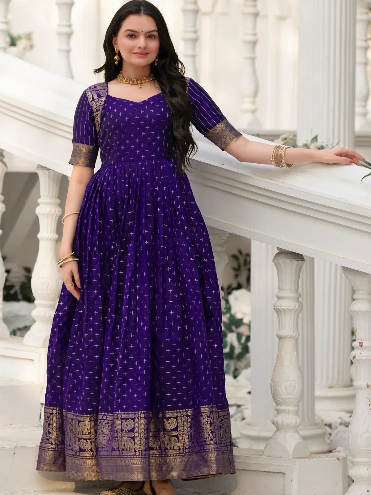 Purple ethnic gown with gold elephant border, perfect for Indian occasions and festive wear.