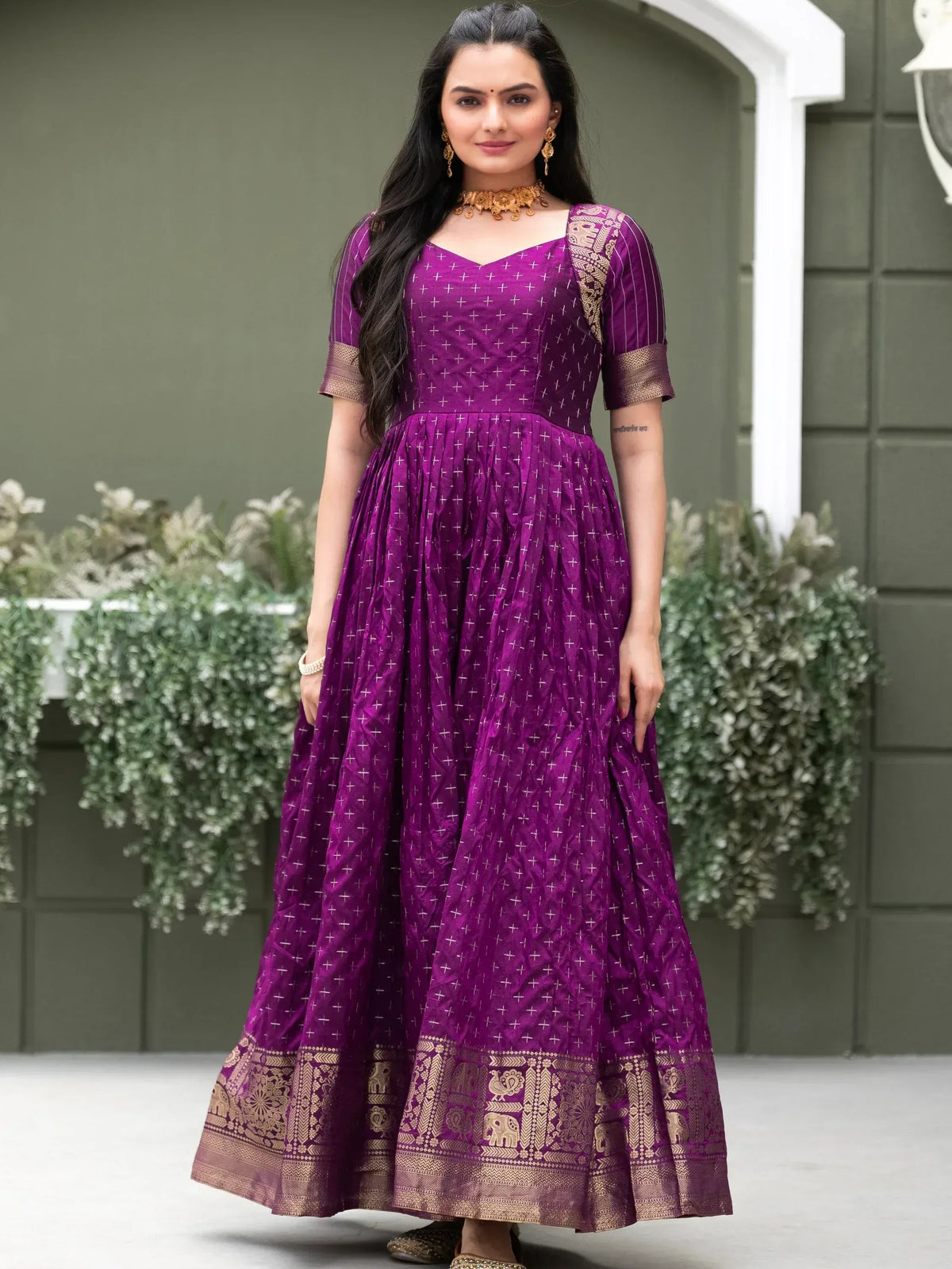 Purple ethnic gown with gold elephant border, perfect for Indian occasions and festive wear.