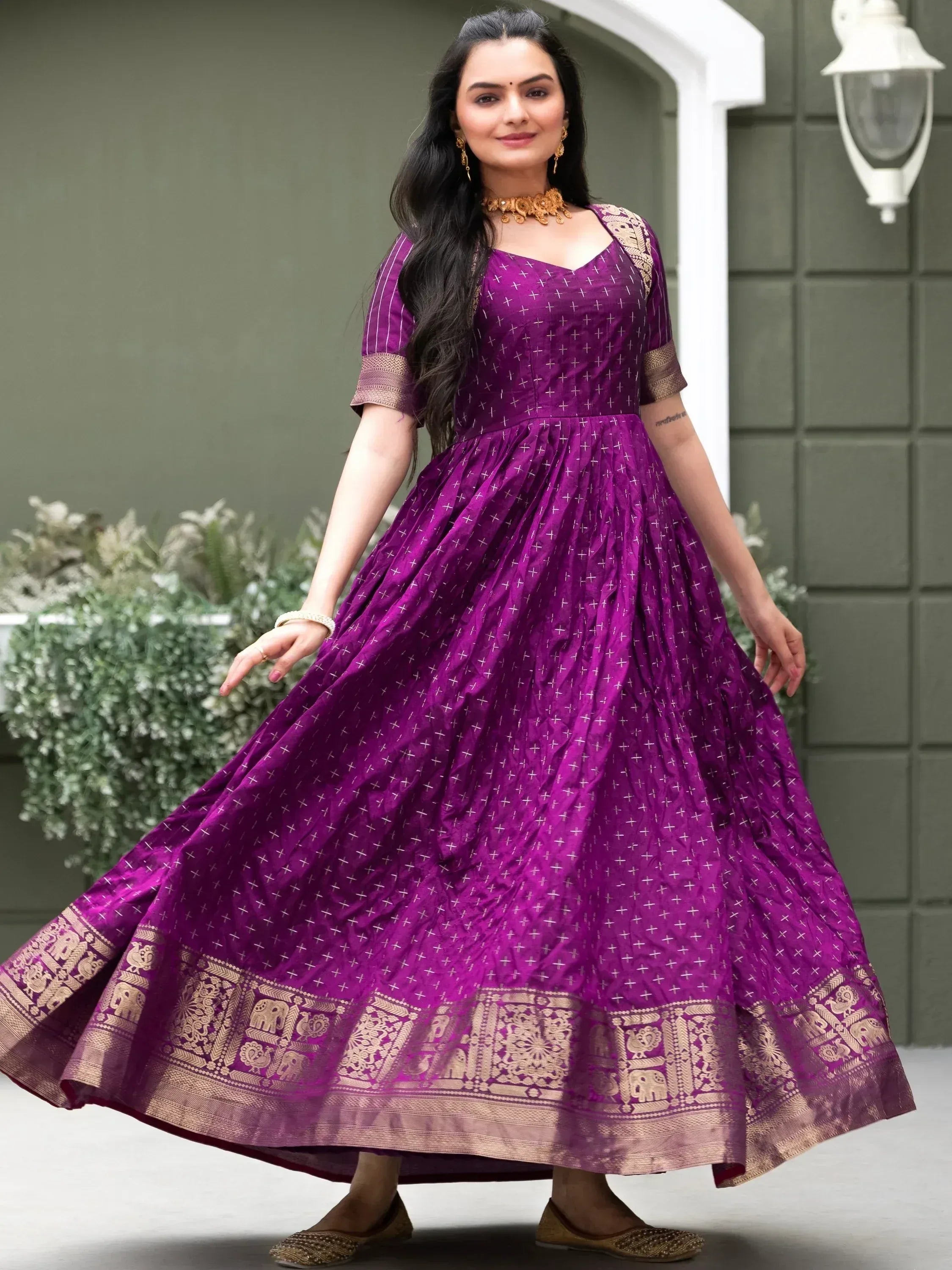 Purple ethnic gown with gold elephant border, perfect for Indian occasions and festivals