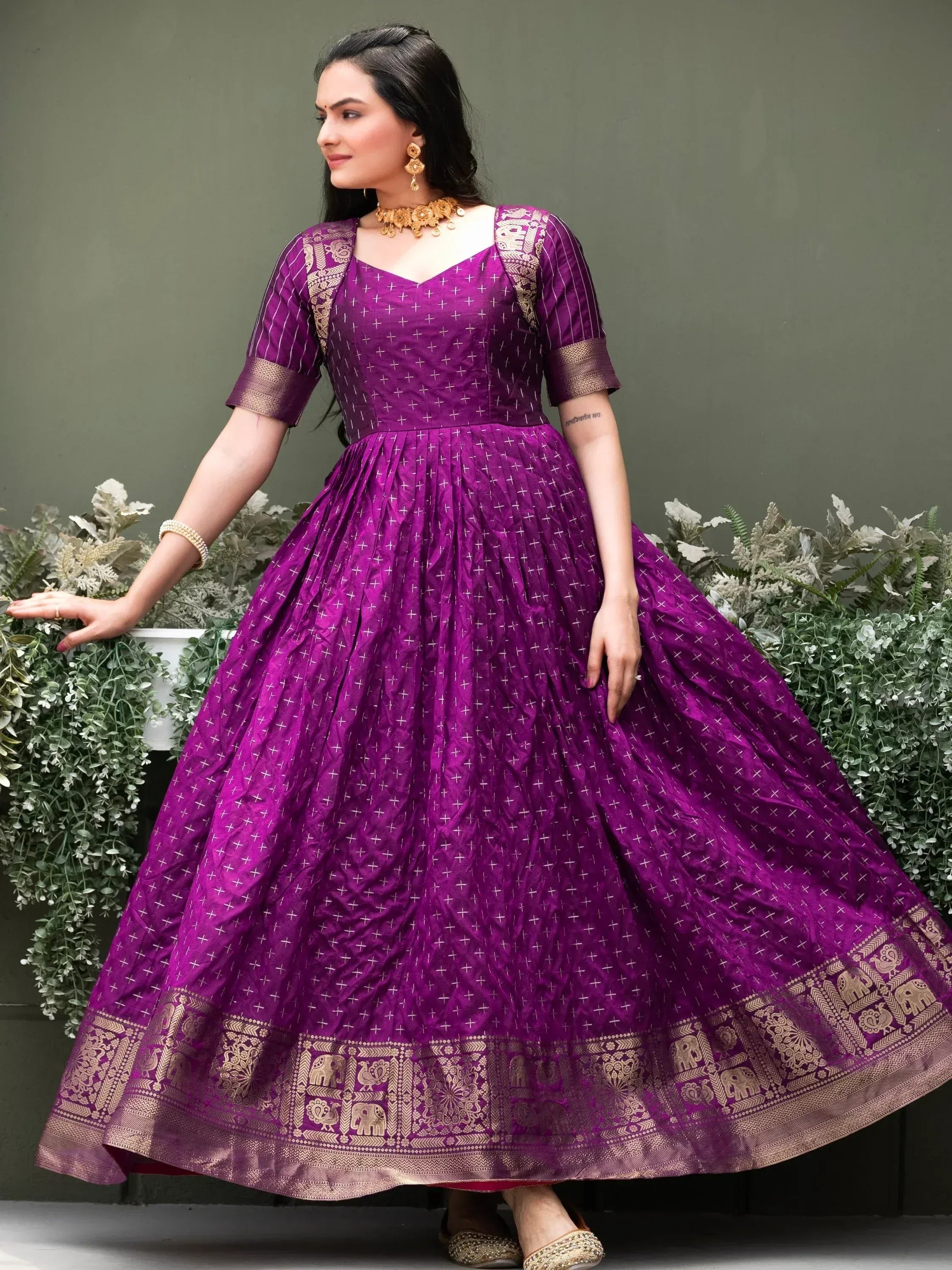 Purple ethnic gown with gold elephant border, perfect for Indian occasions and festivals