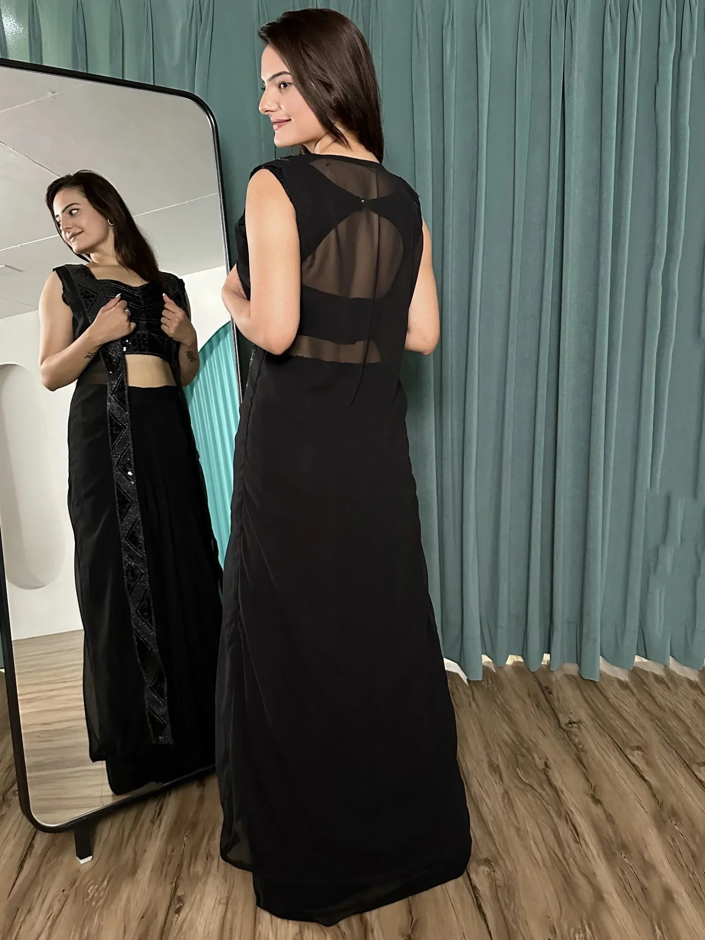 Black ethnic gown with sheer back detail, perfect for Indian occasions. Stylish and elegant designer wear.