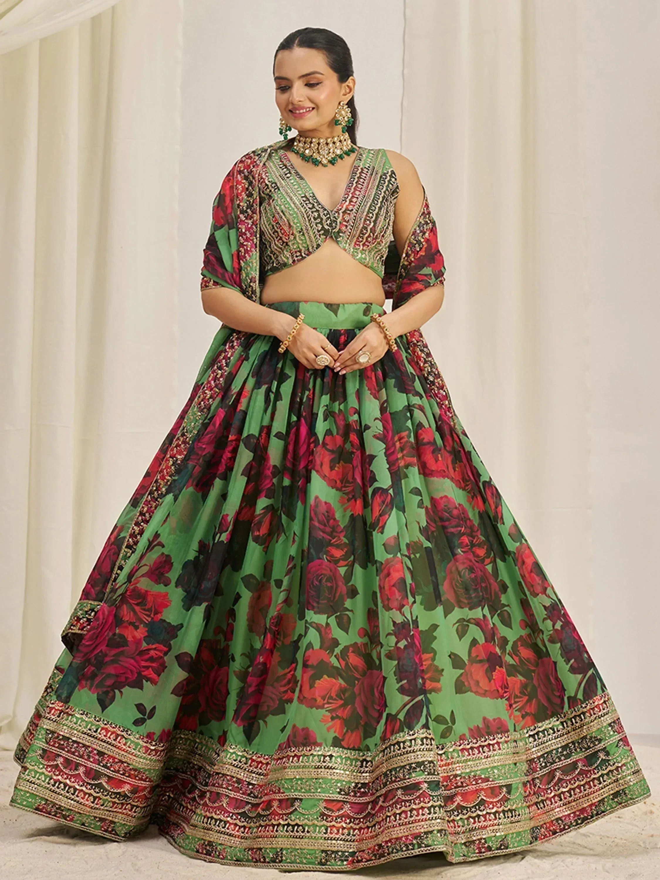 Green and red floral lehenga choli with embroidered dupatta, perfect for Indian weddings and festive occasions.
