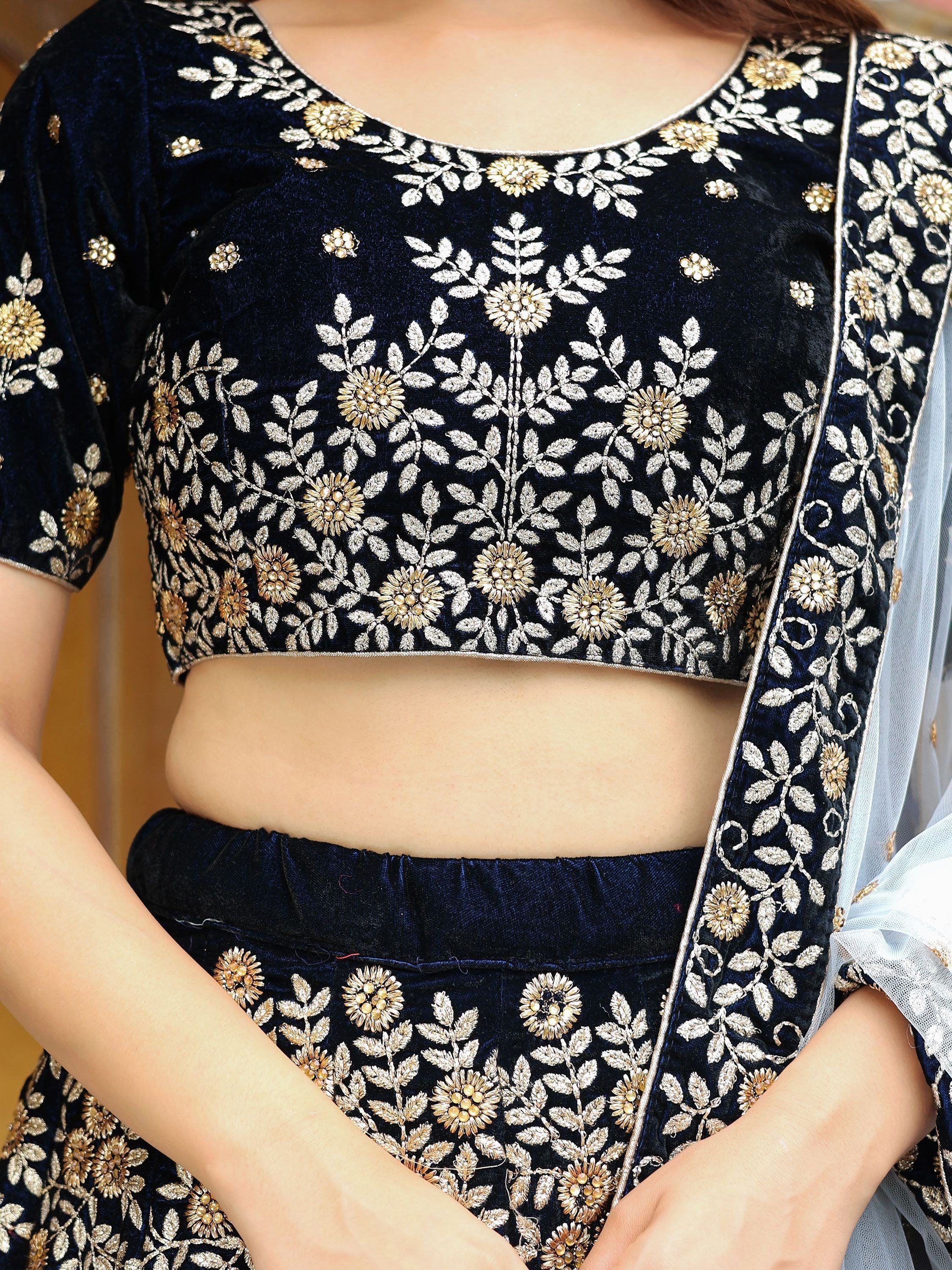 Navy blue velvet lehenga choli with gold floral embroidery, perfect for Indian ethnic wear events.