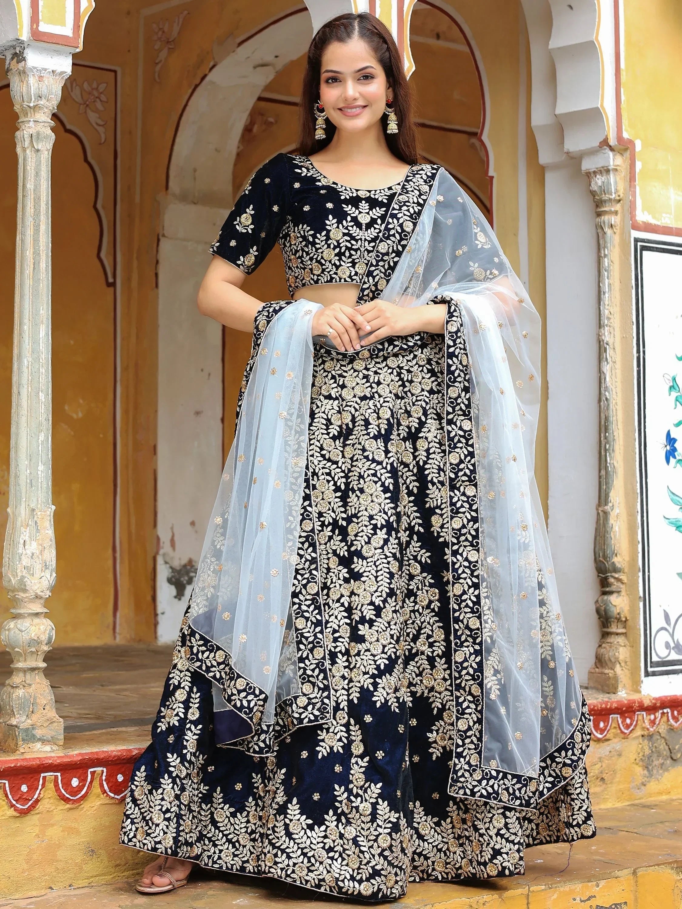 Elegant navy blue embroidered lehenga choli with sheer dupatta, perfect for Indian ethnic occasions.