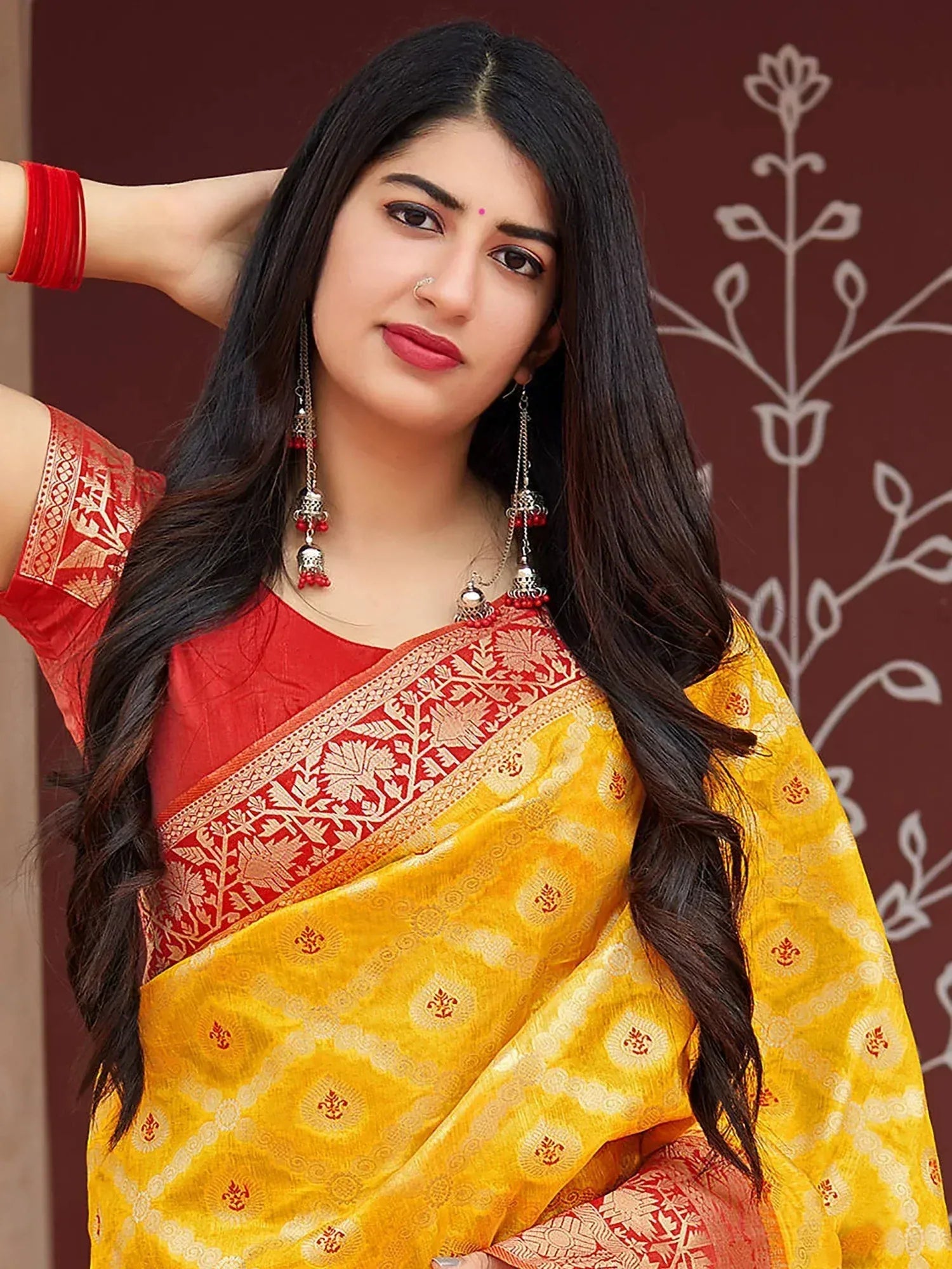 Yellow and red ethnic saree with floral border, perfect for Indian occasions and festive wear.