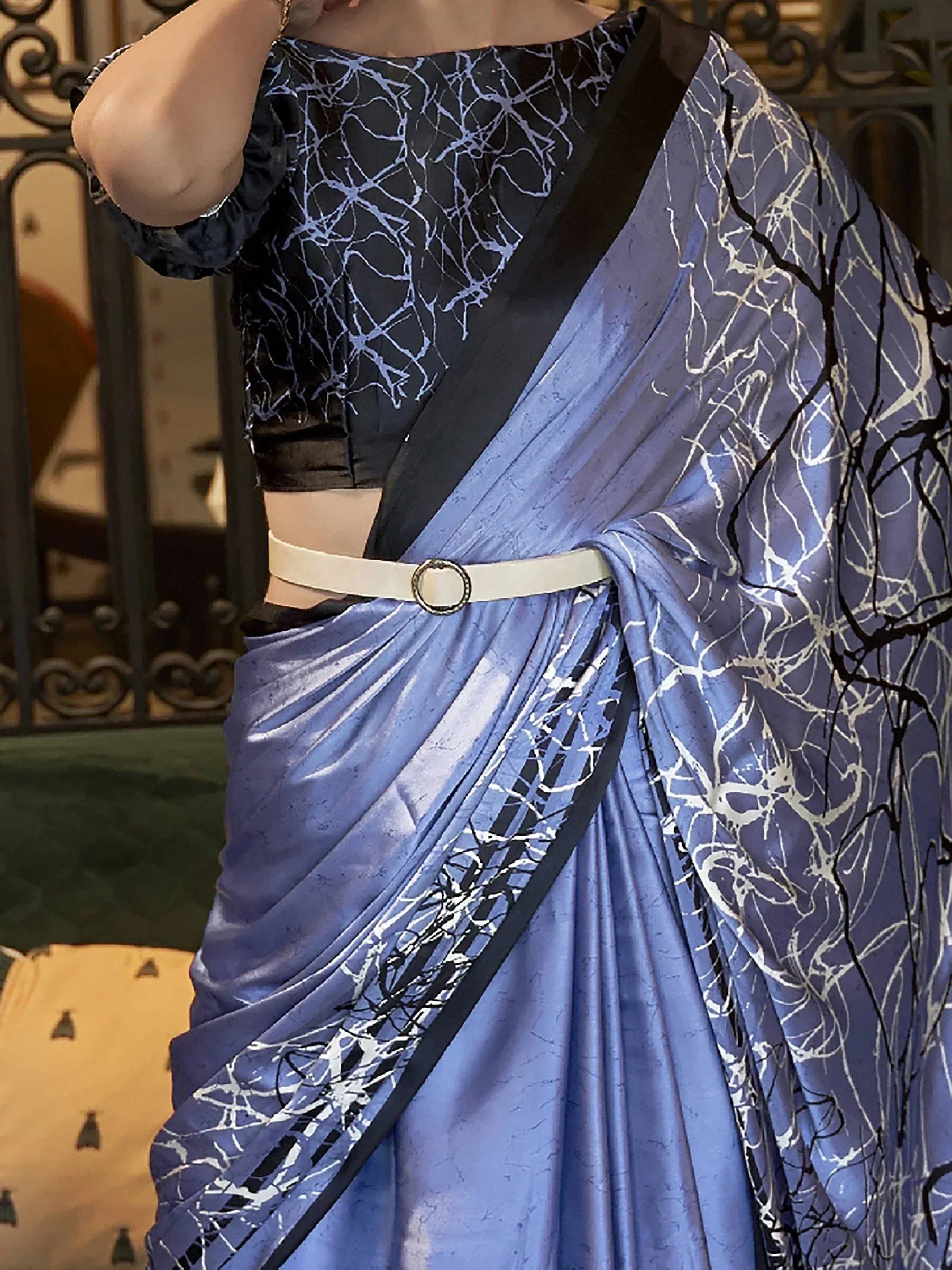Blue printed saree with black blouse, white belt, and abstract branch pattern for ethnic wear